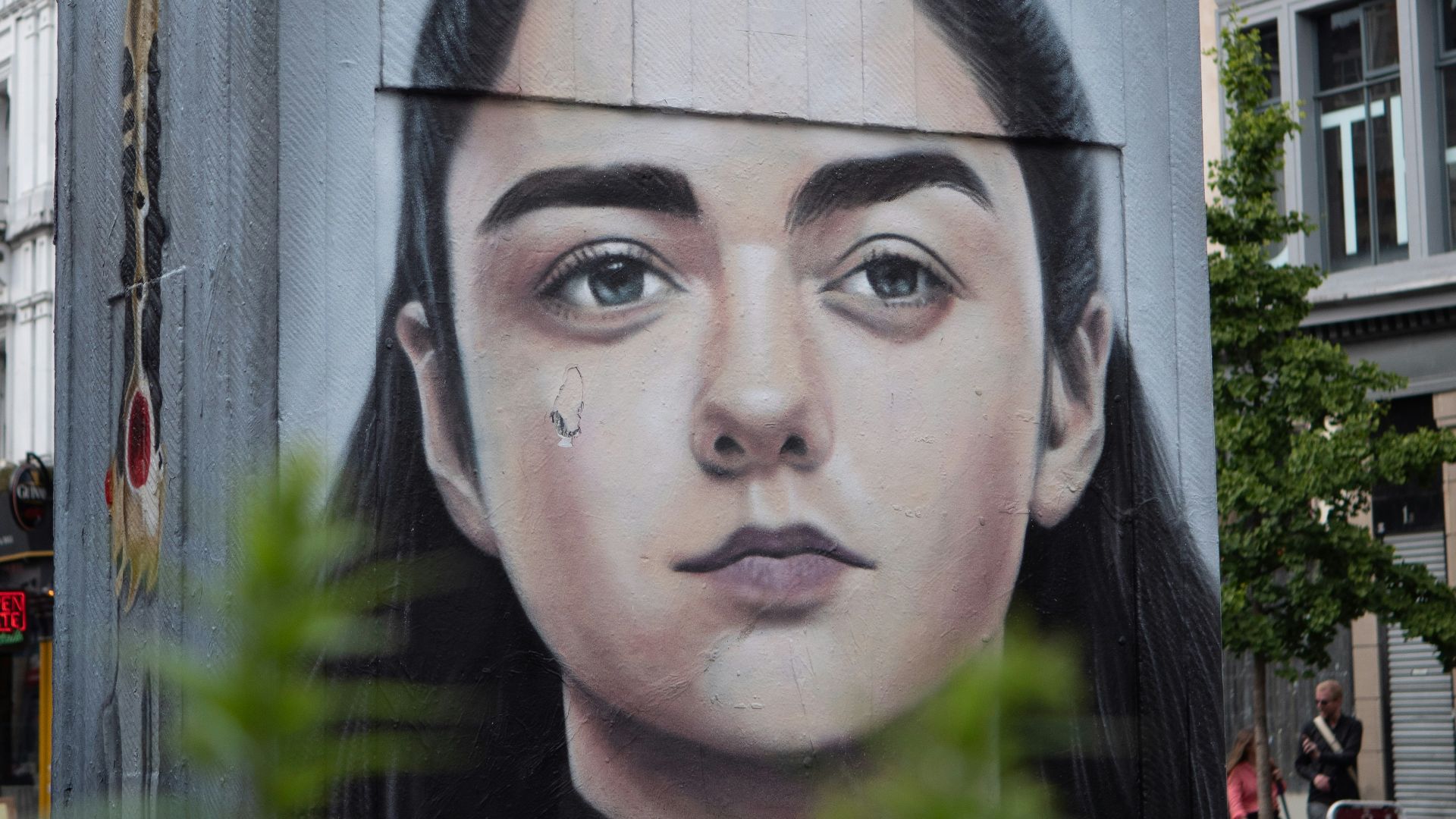 man in black shirt standing near building