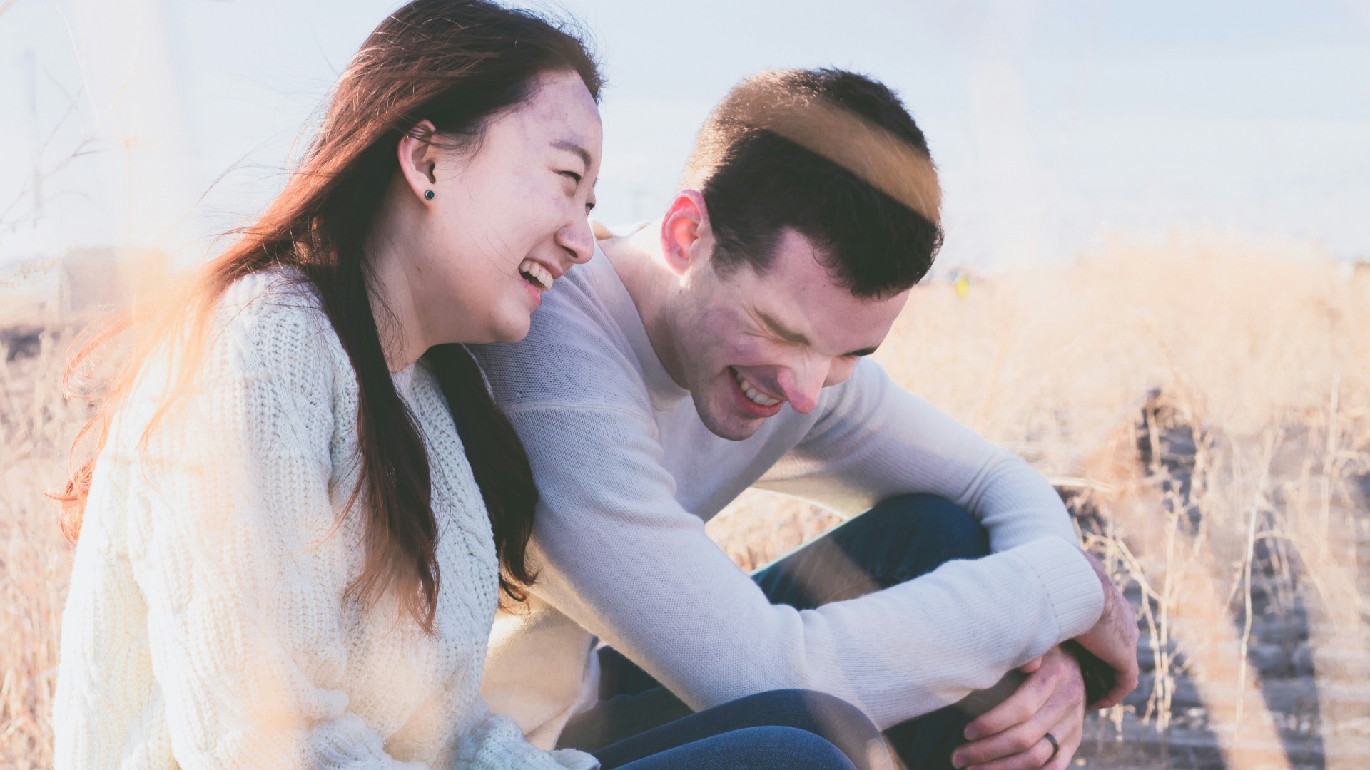 photo of man and woman laughing during daytime