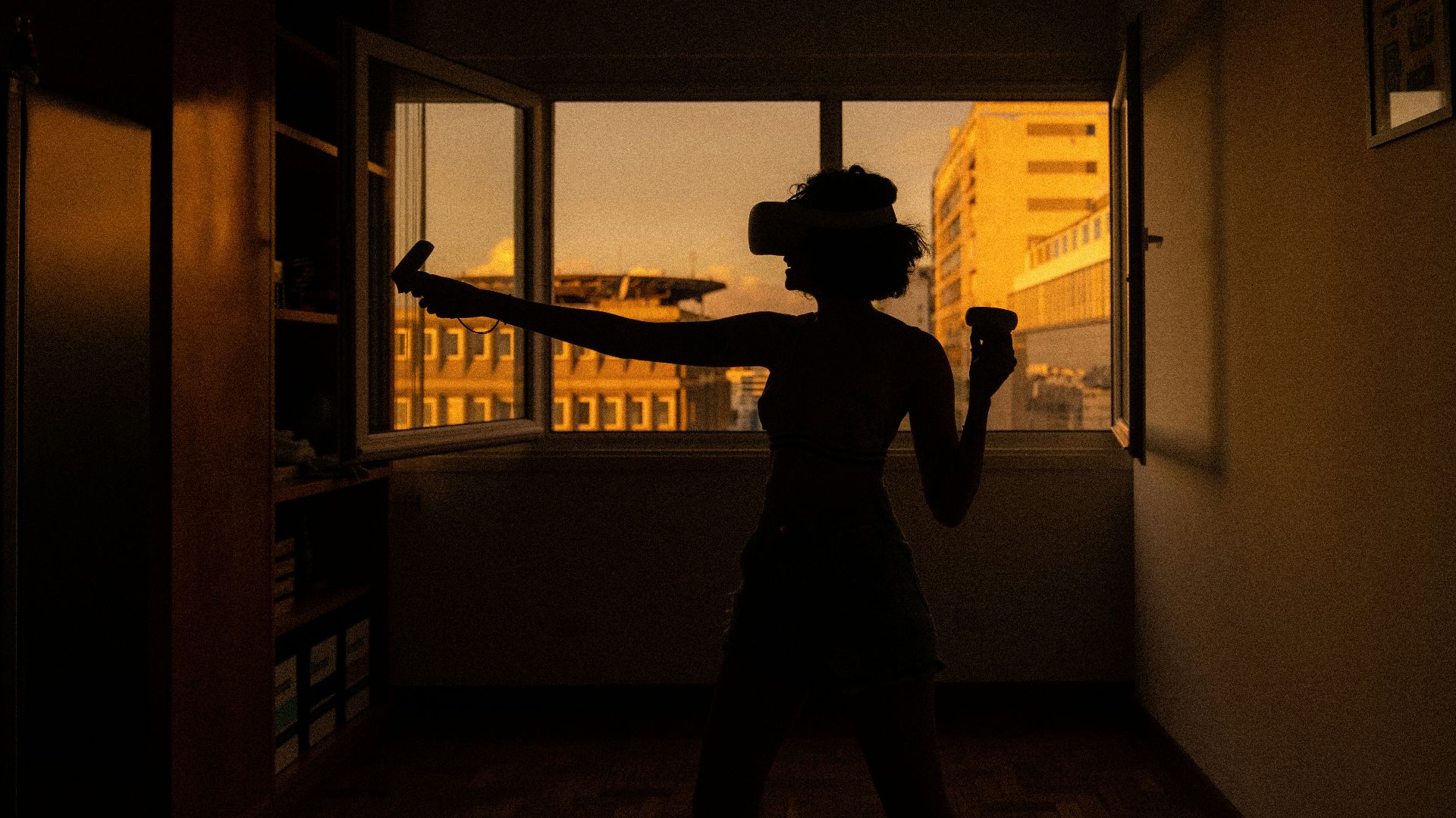 silhouette of man standing near window