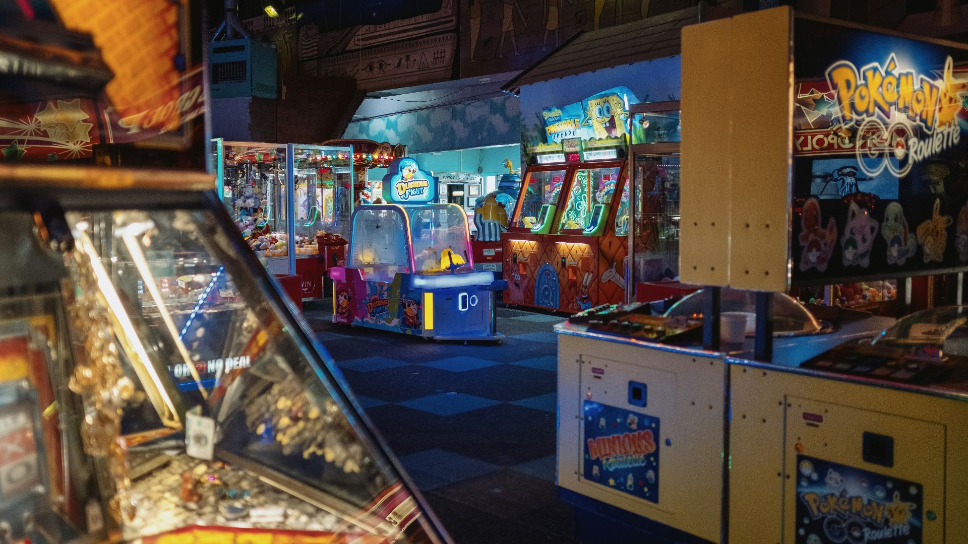 a row of pinball machines sitting next to each other