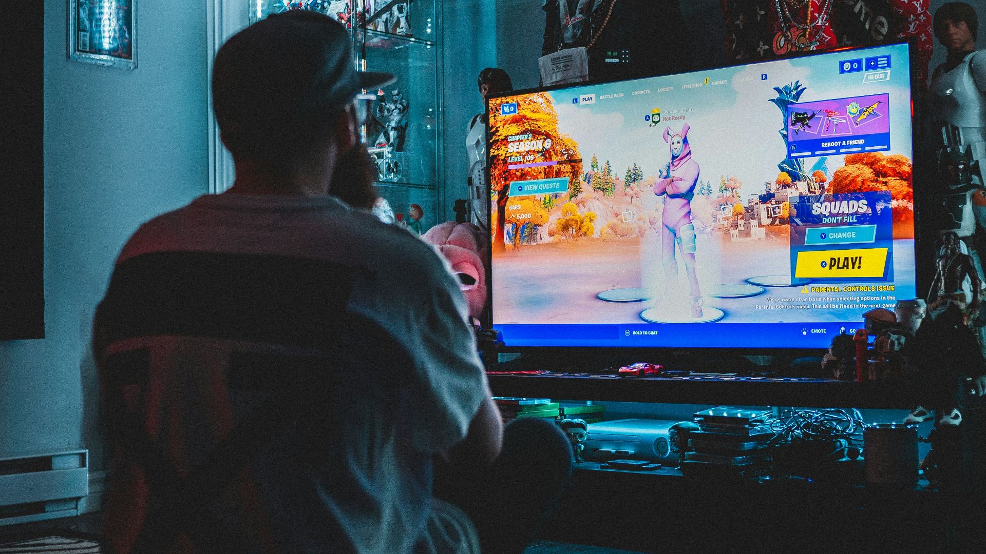 man in red shirt watching tv