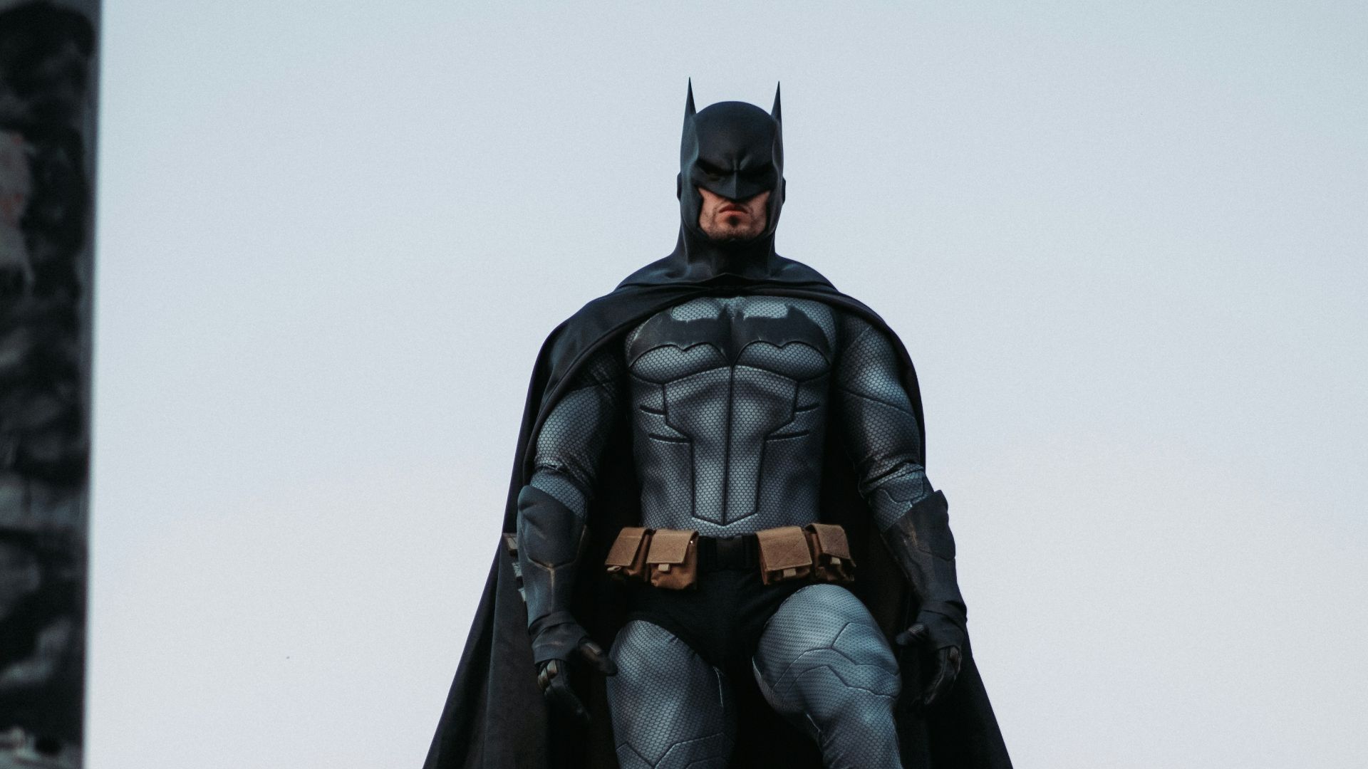 man in black jacket and pants standing on roof