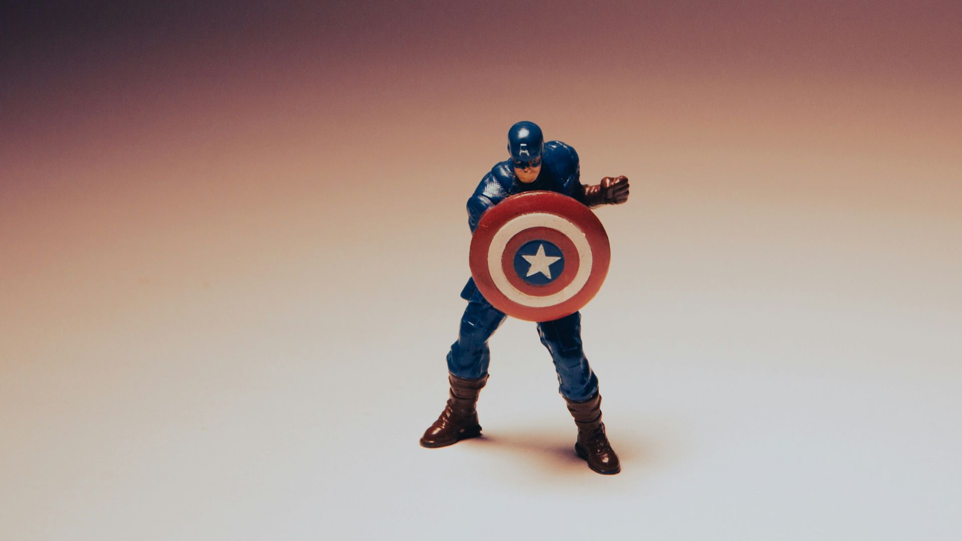 a toy of a captain america holding a shield