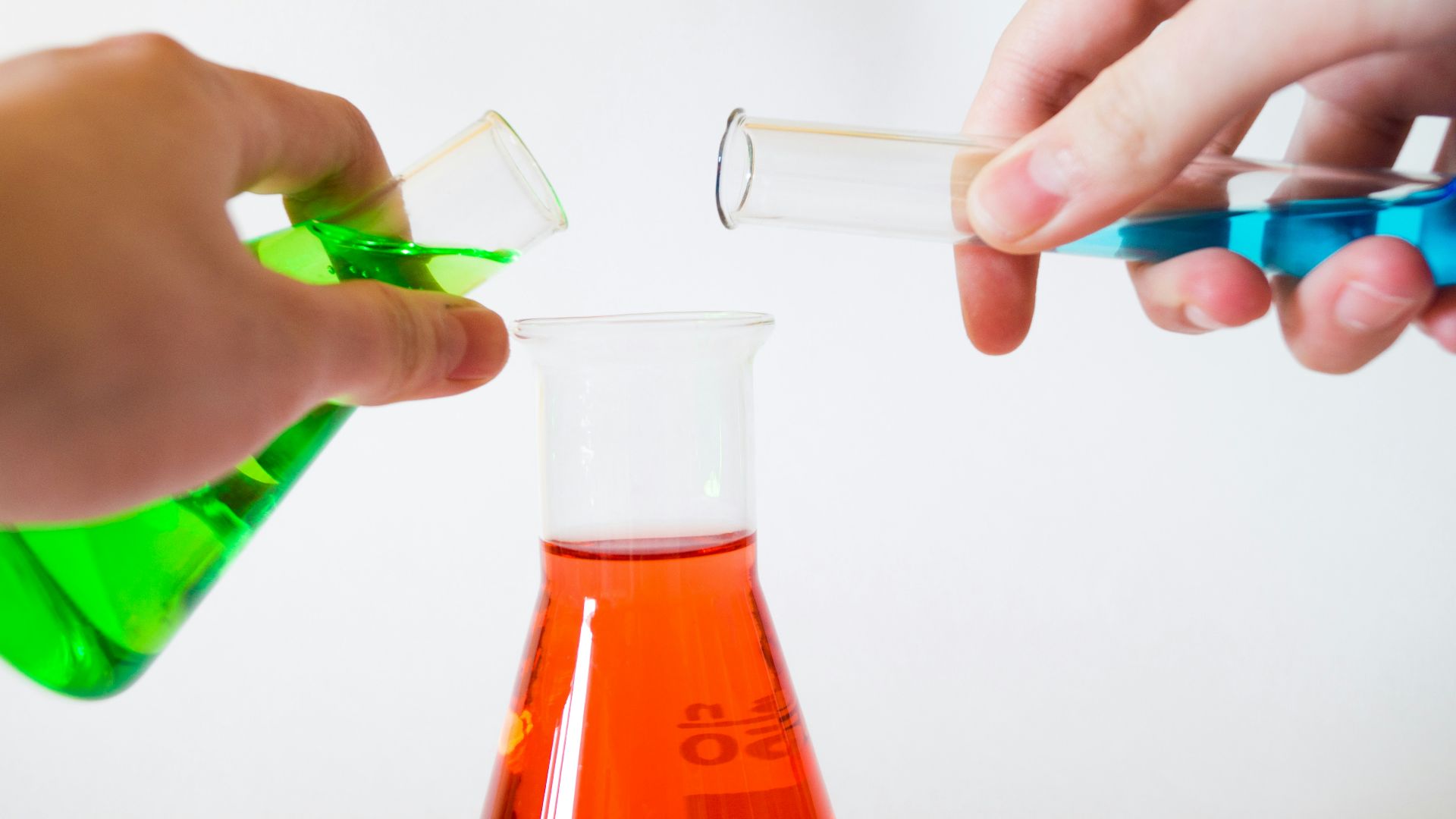person holding laboratory flasks