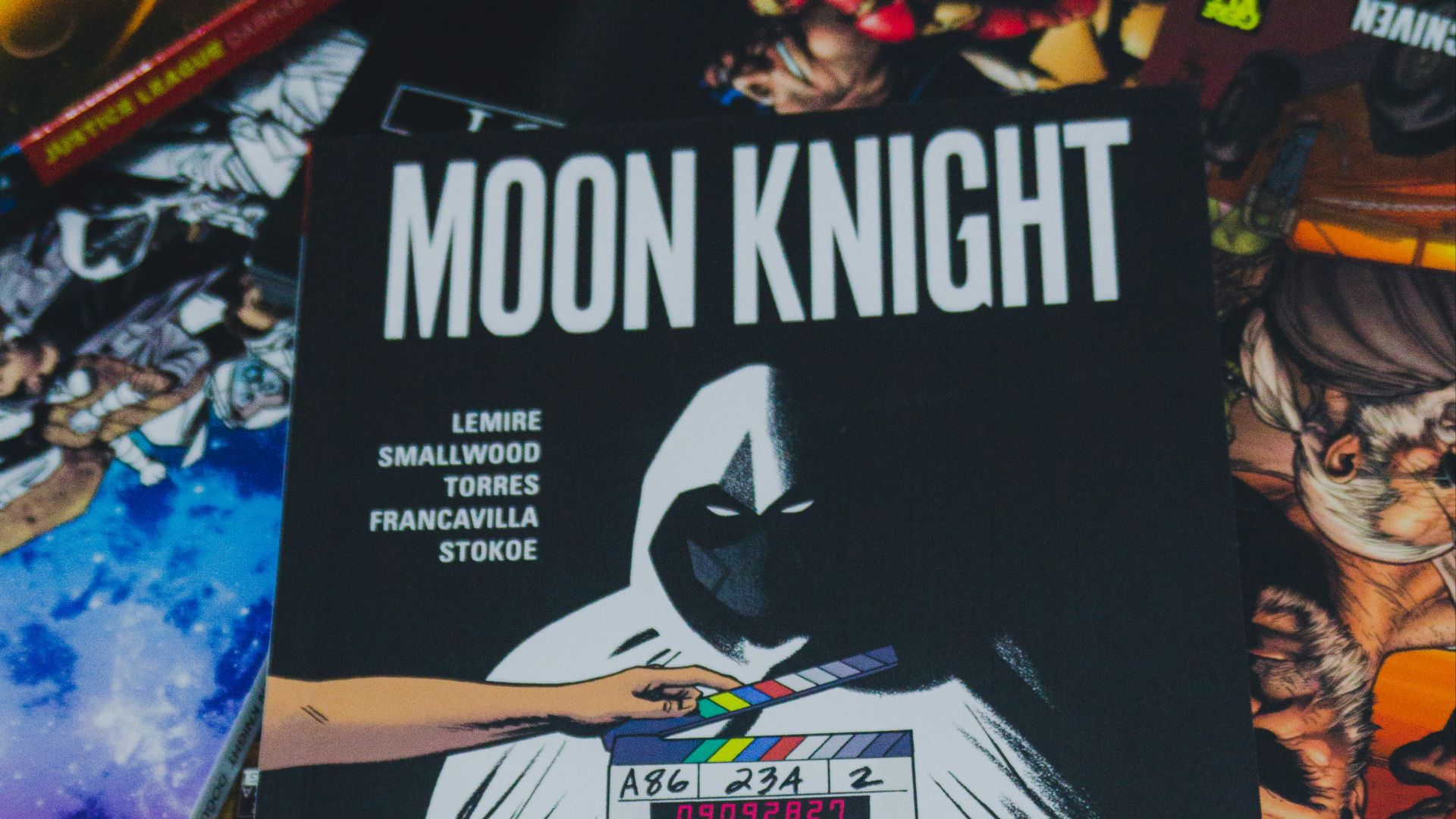 a pile of comic books sitting on top of a table