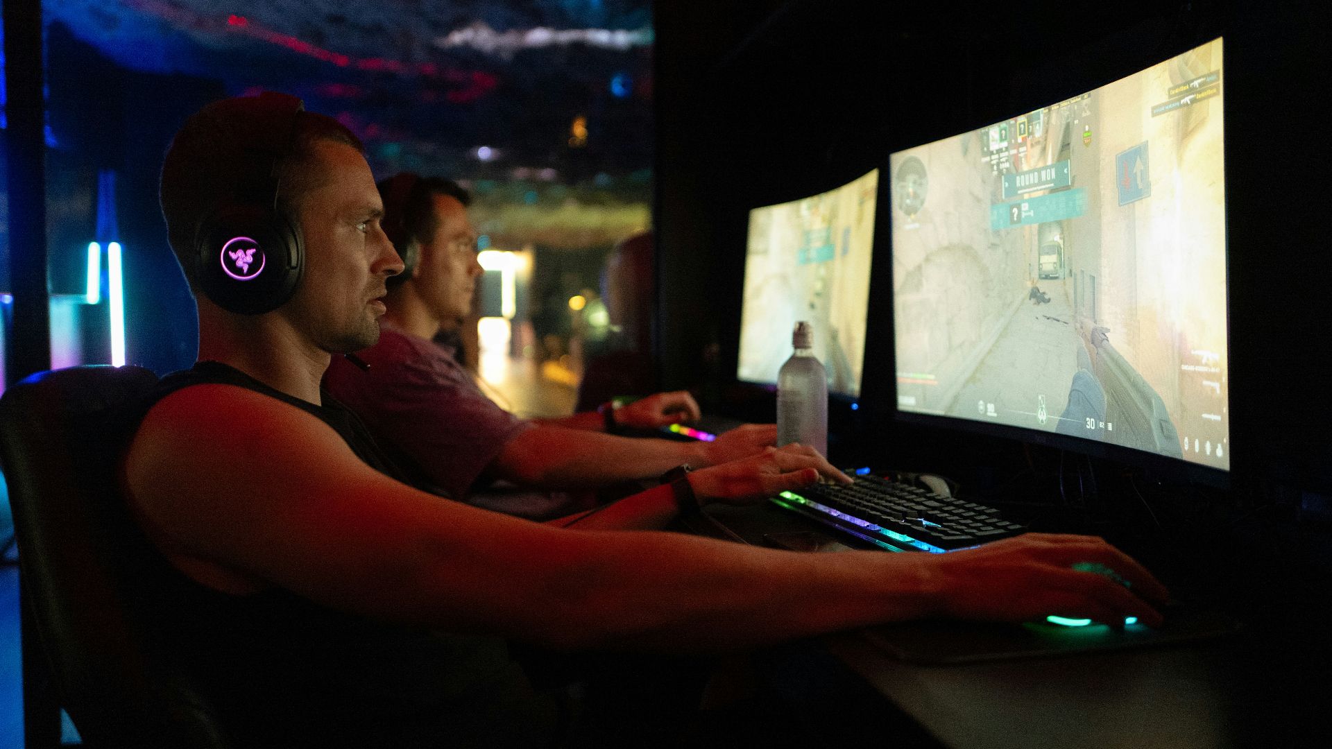 Two men playing video games on computers