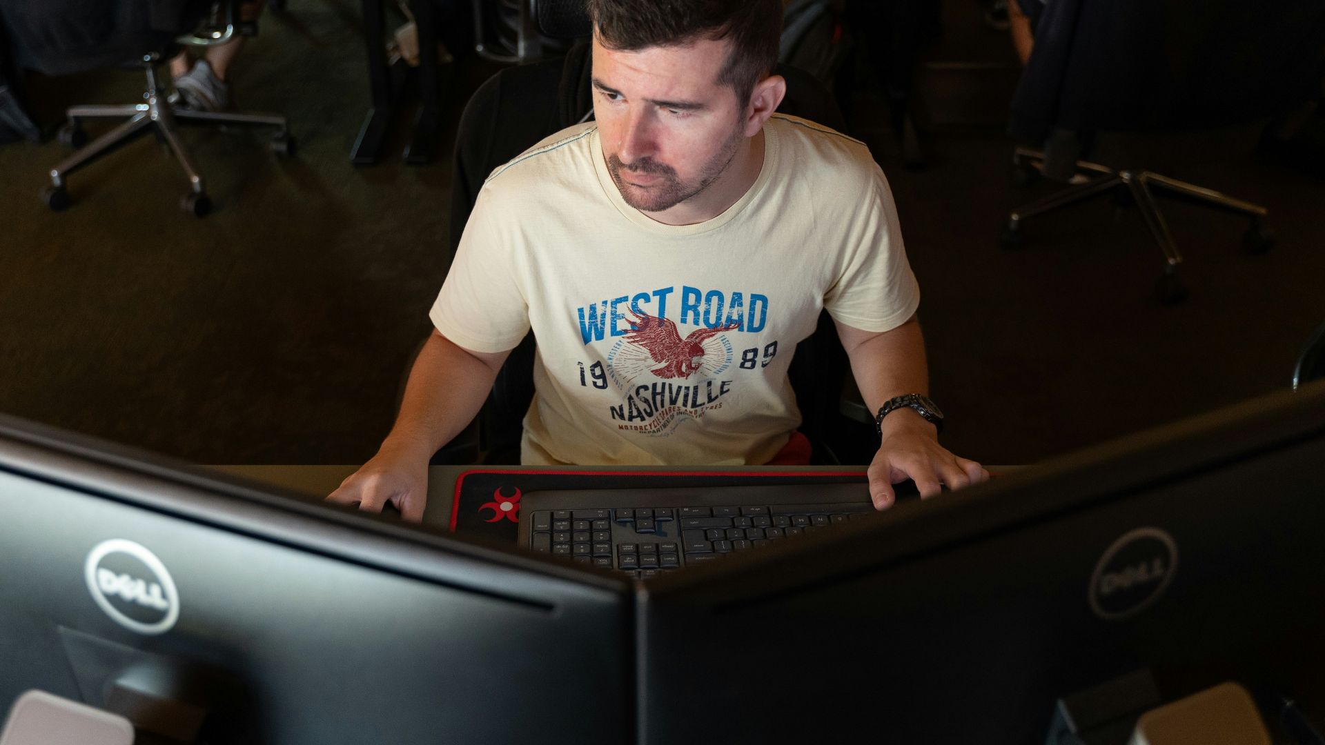 a man sitting in front of a computer monitor