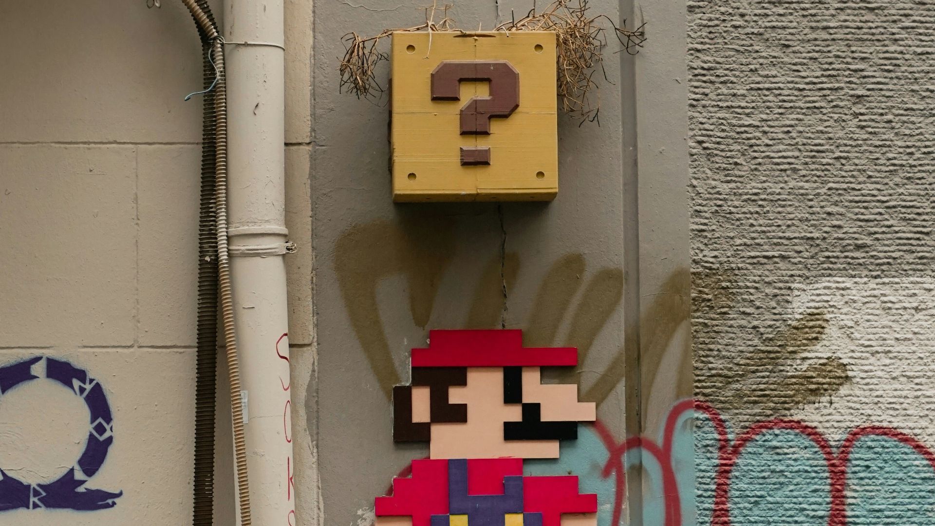 a wall with graffiti and a nintendo character on it
