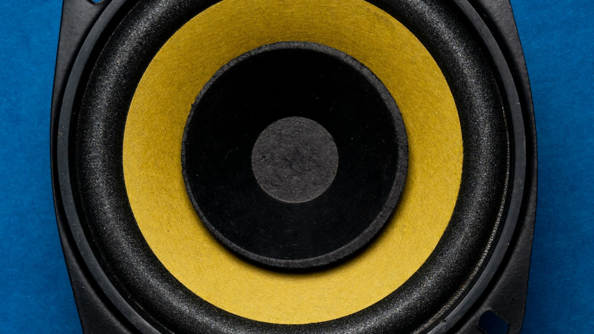 a close up of a speaker on a blue surface