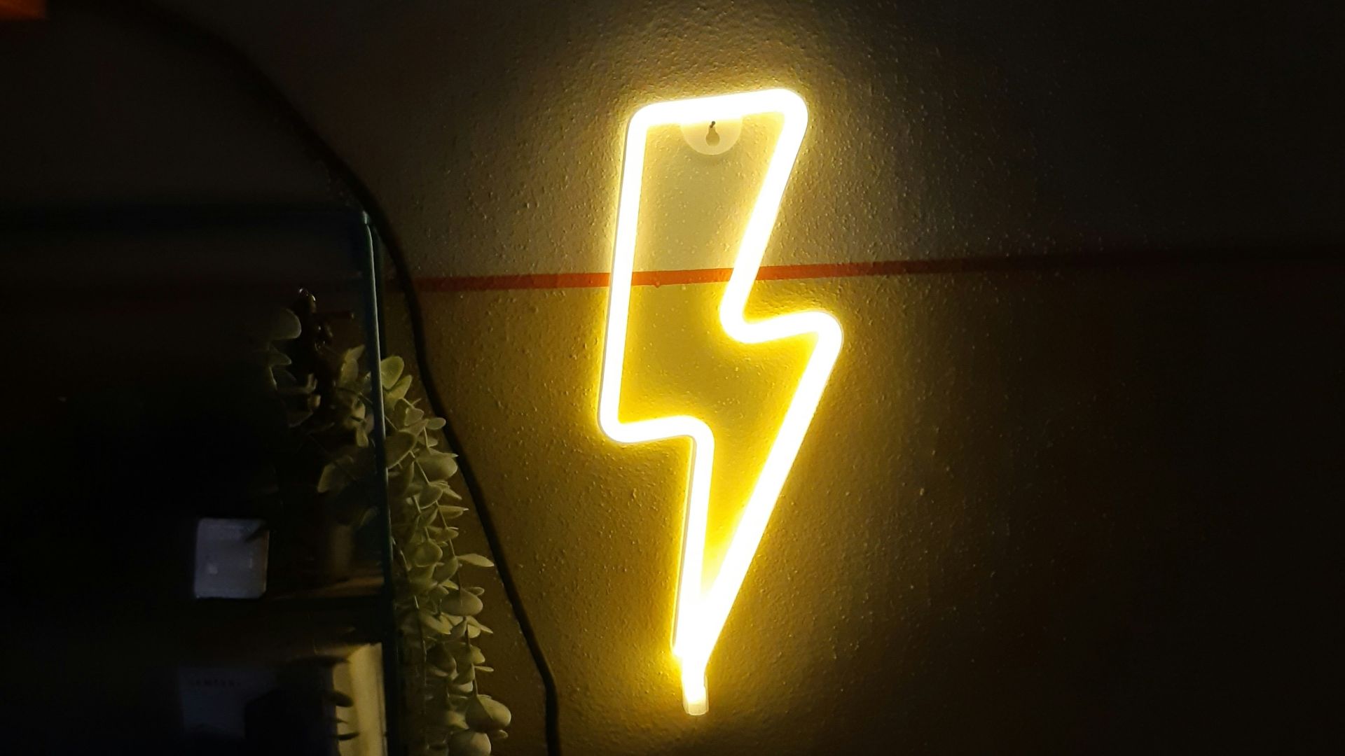a neon sign that is on the side of a wall
