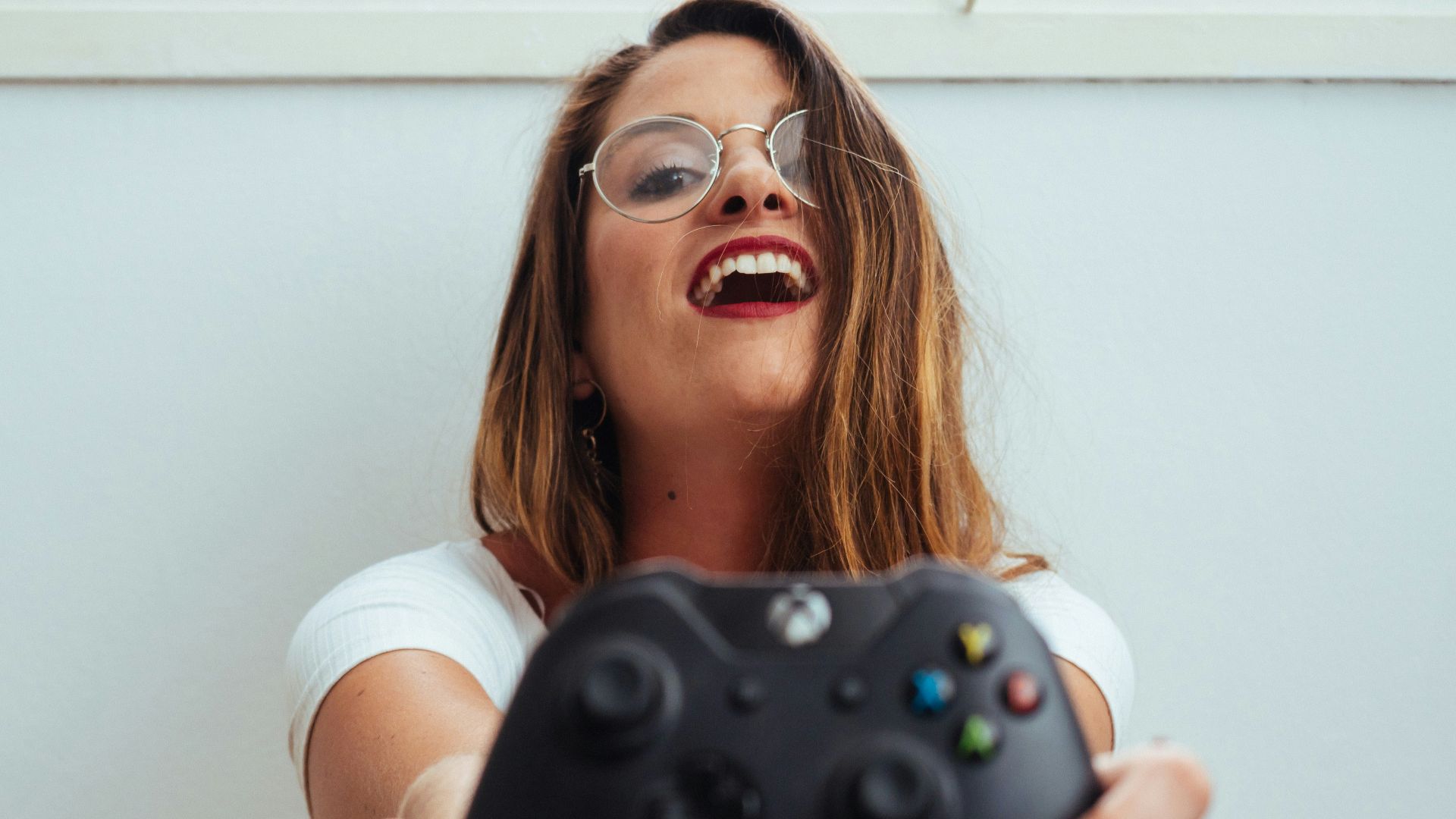 woman holding Xbox One controller
