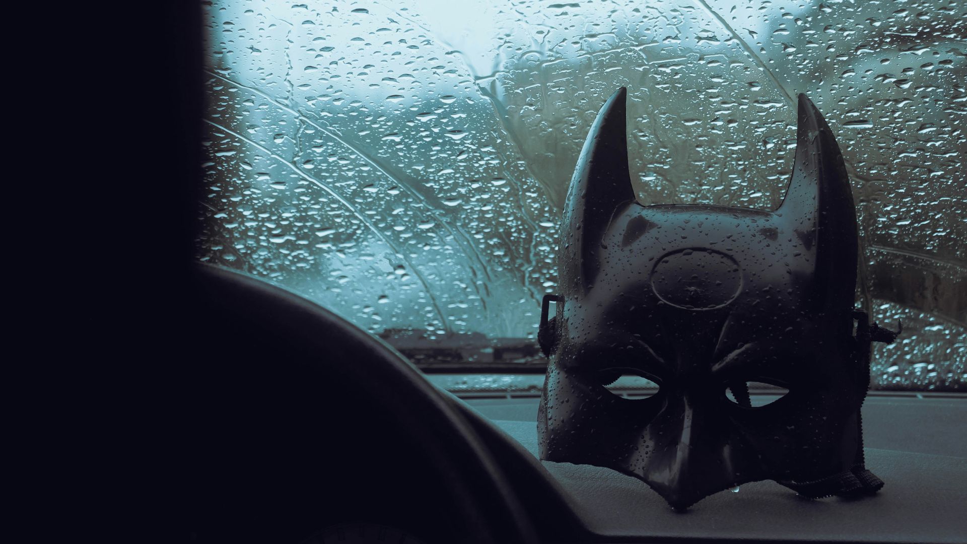 a batman mask sitting on top of a dashboard