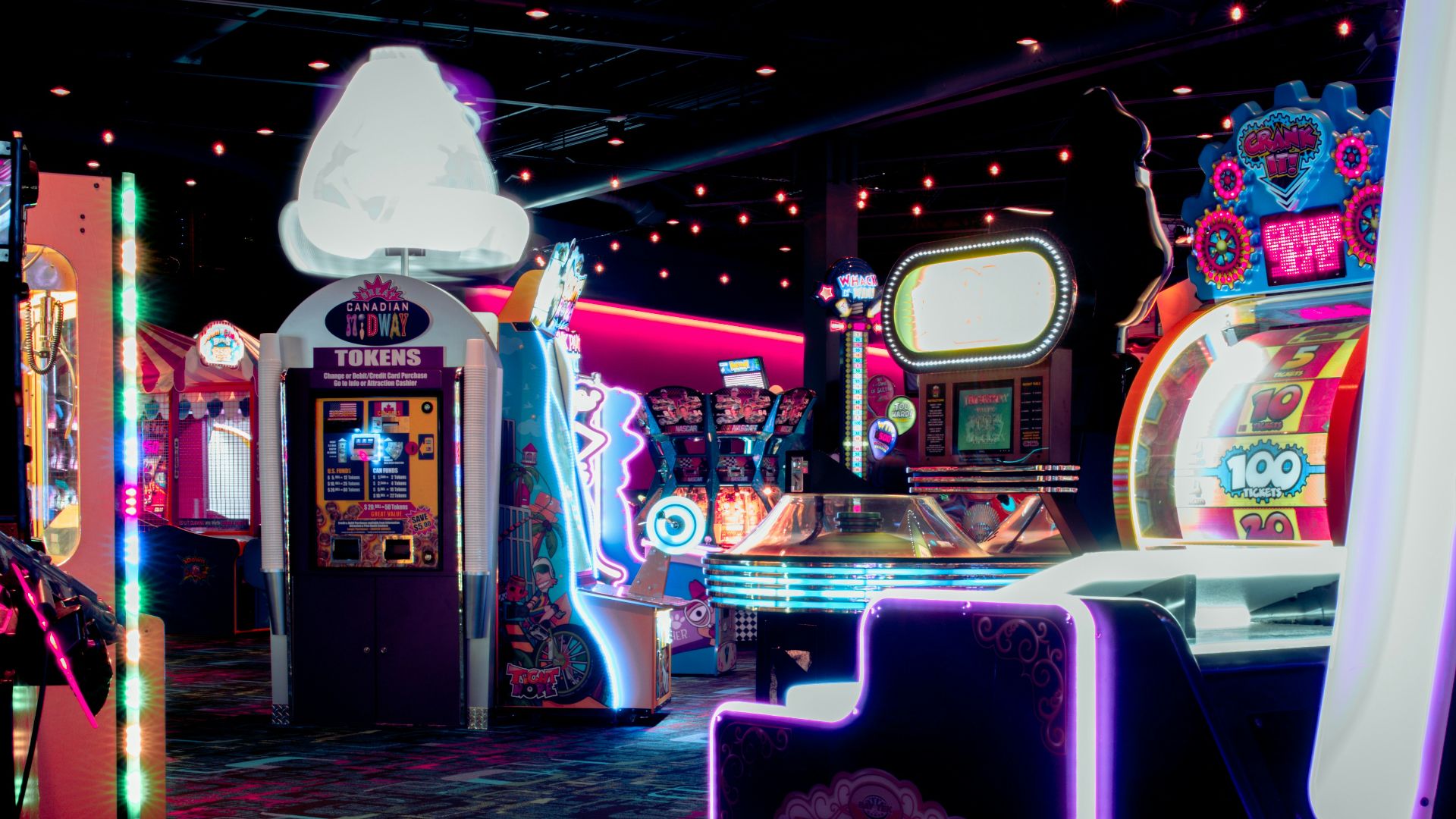 a room filled with arcade machines and neon lights
