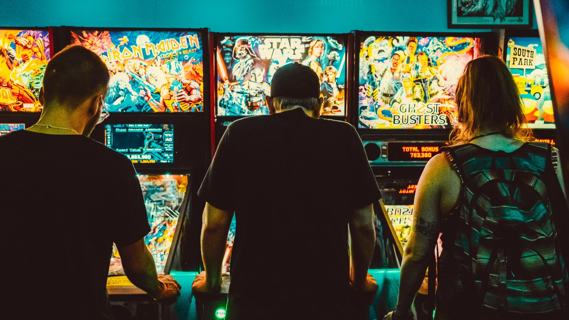 people playing arcade machines