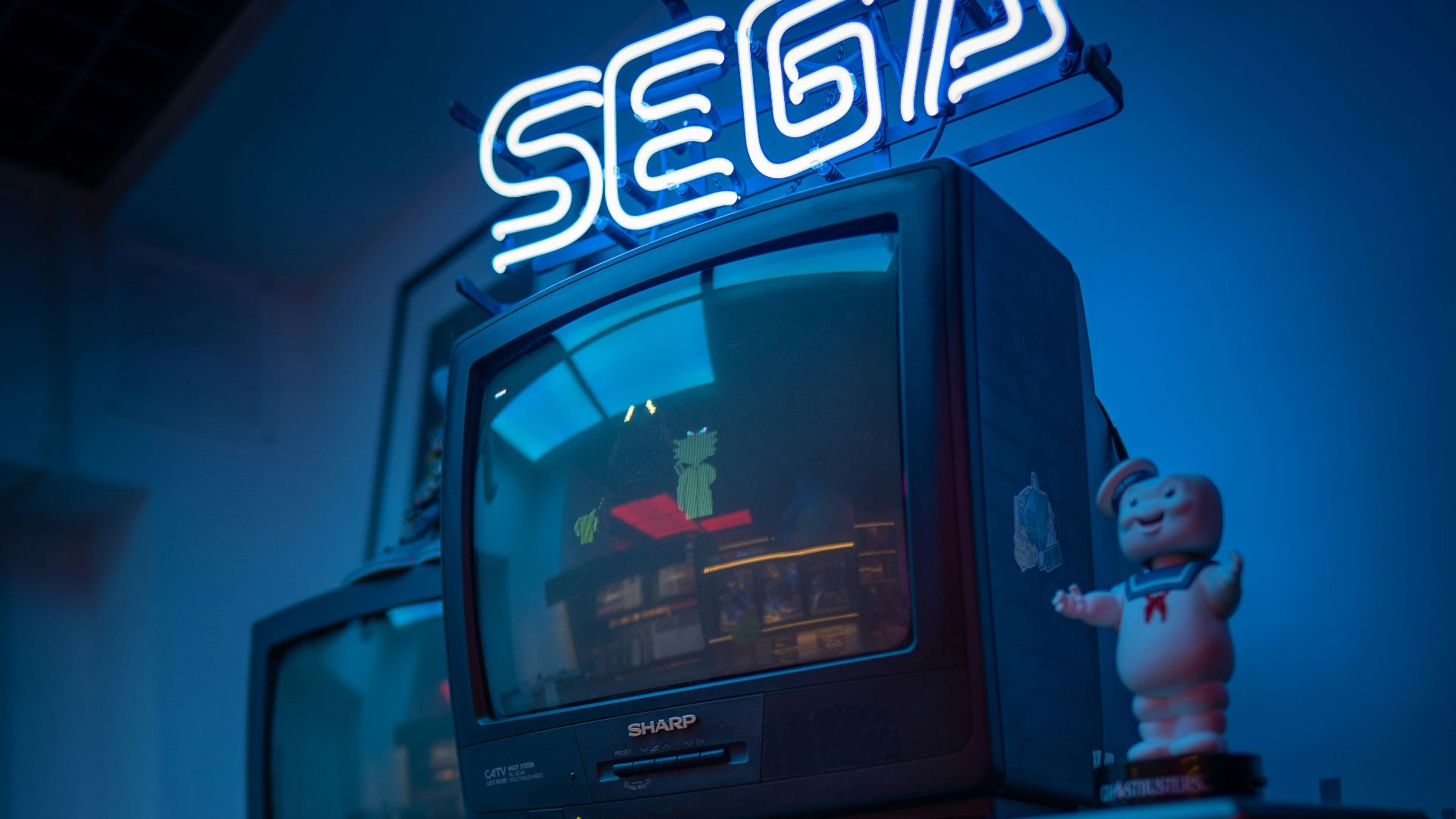 black crt tv turned on on brown wooden tv rack