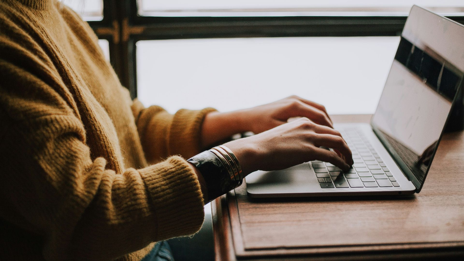 person sitting front of laptop