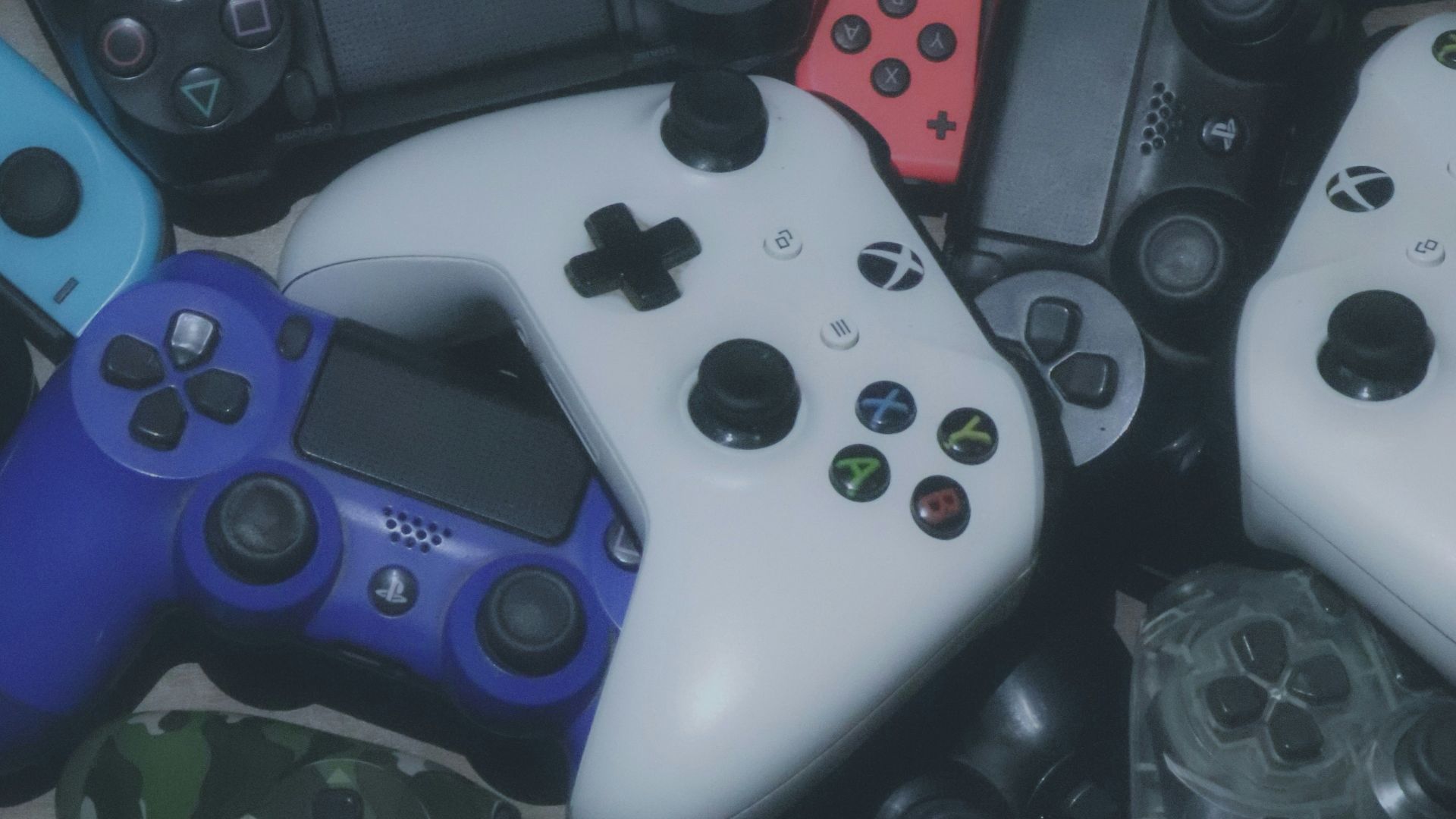 assorted-colored Xbox and Sony Playstaion game controller lot