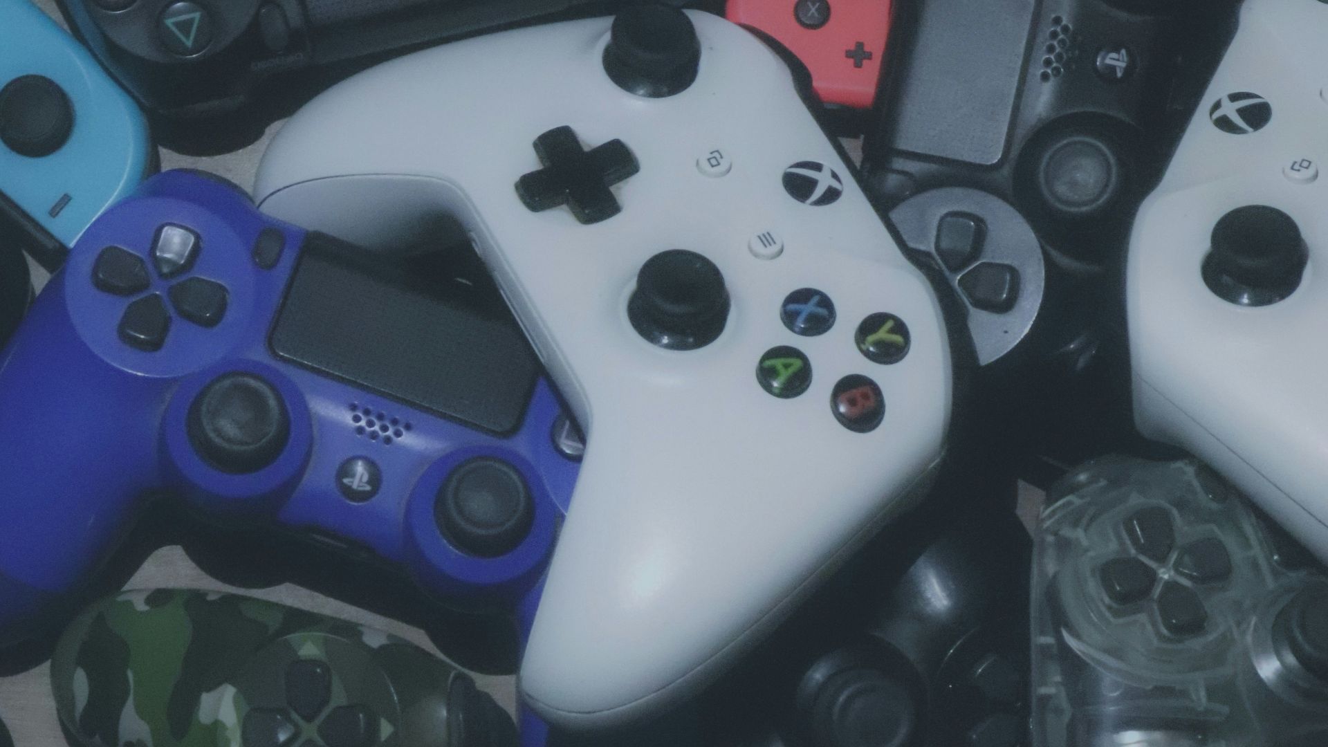 assorted-colored Xbox and Sony Playstaion game controller lot