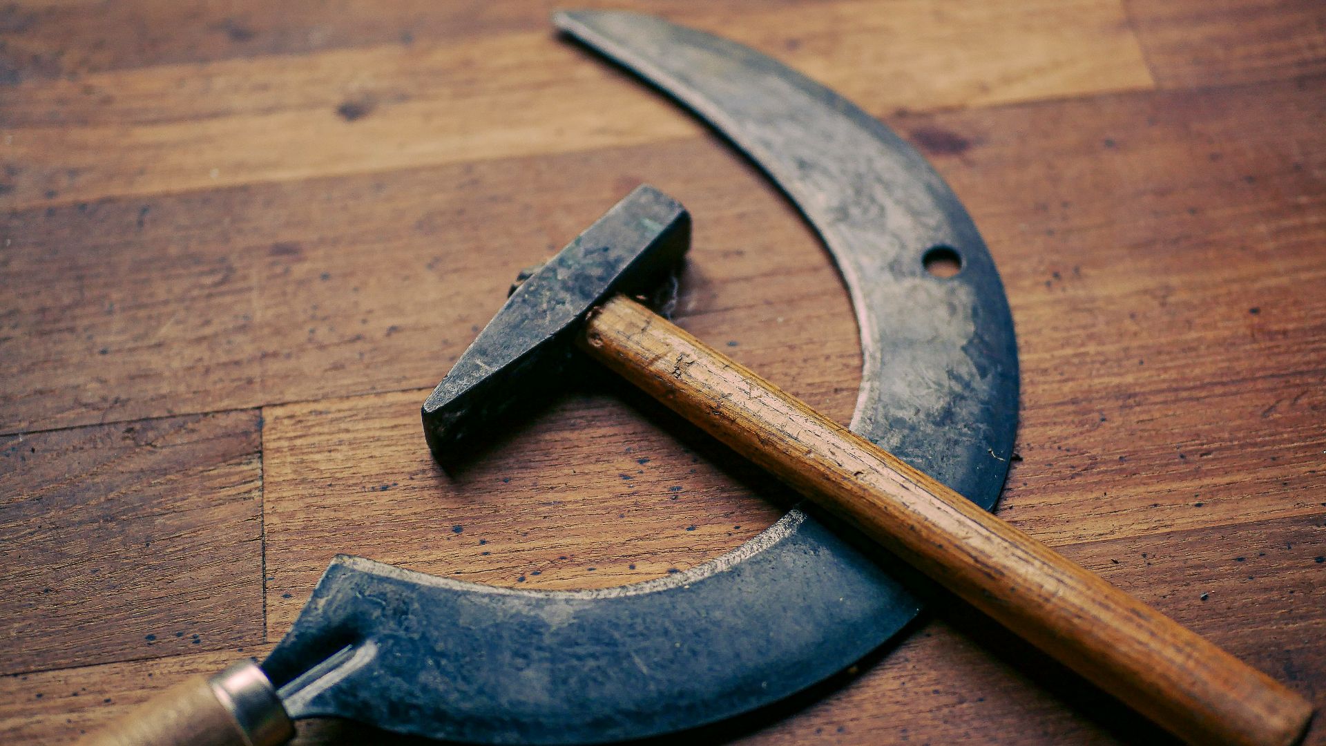 a hammer and a sick hammer on a wooden floor