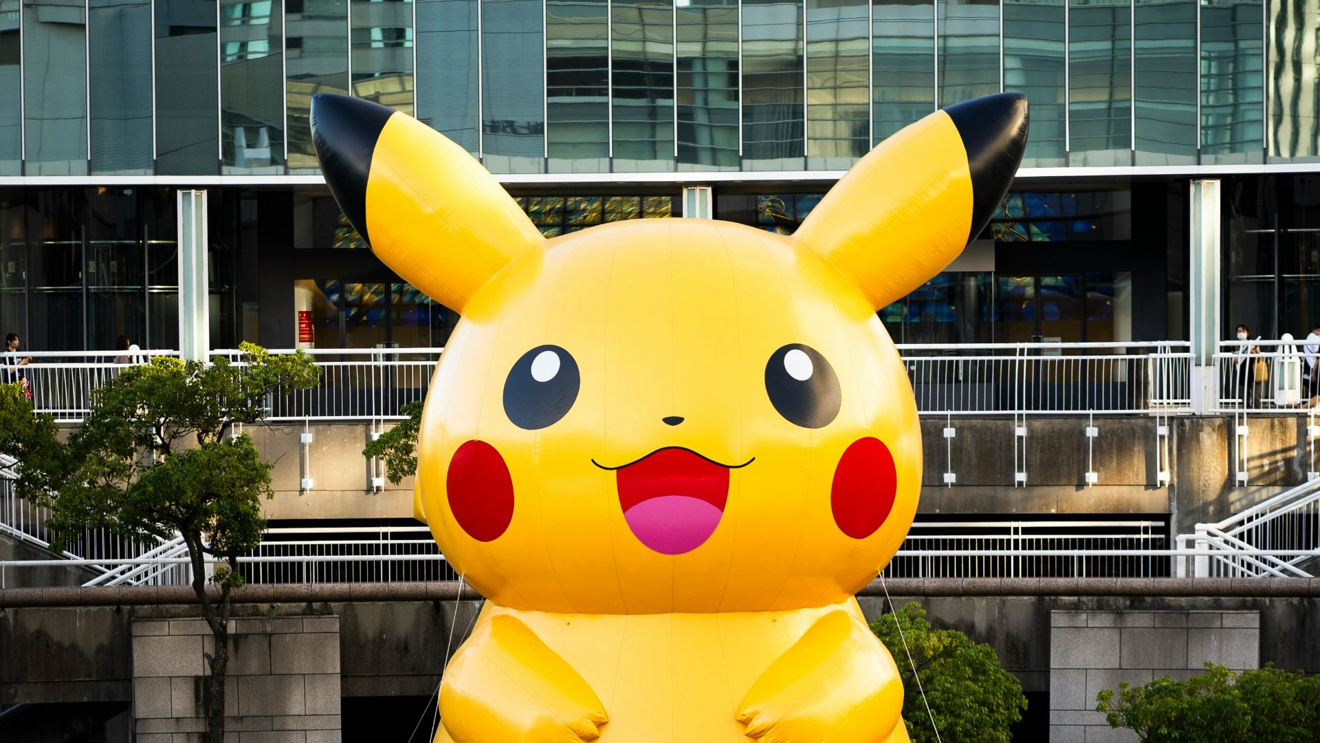 A group of people standing in front of a giant pikachu