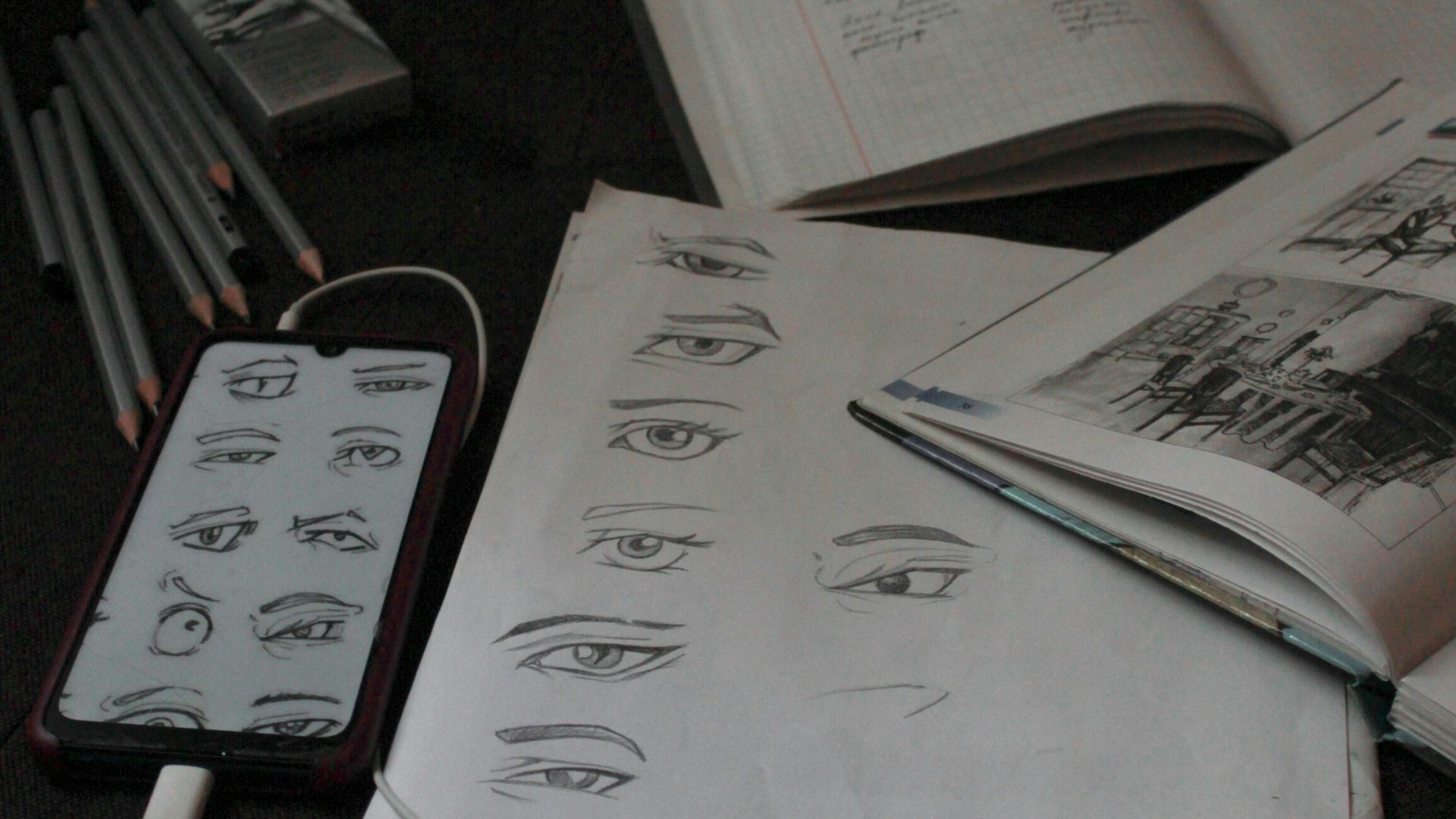 a bunch of papers and a cell phone on a table