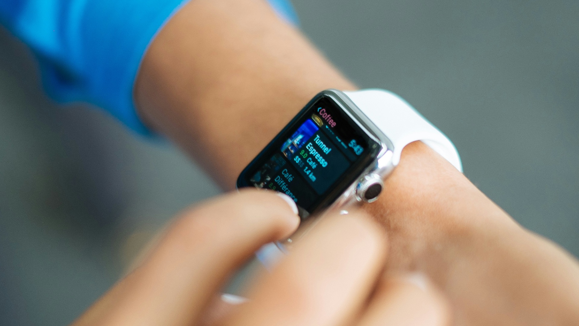 person wearing silver Apple Watch with white Sport Band
