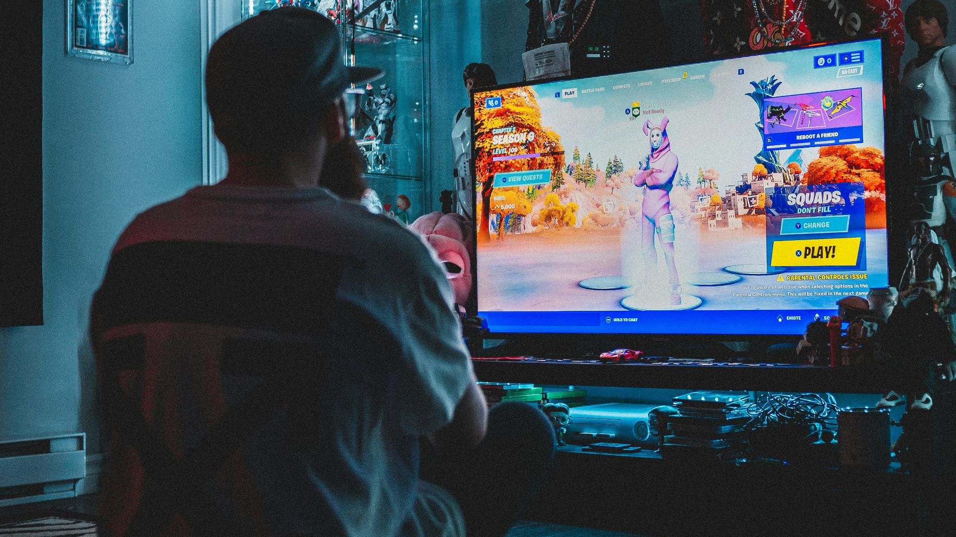 man in red shirt watching tv
