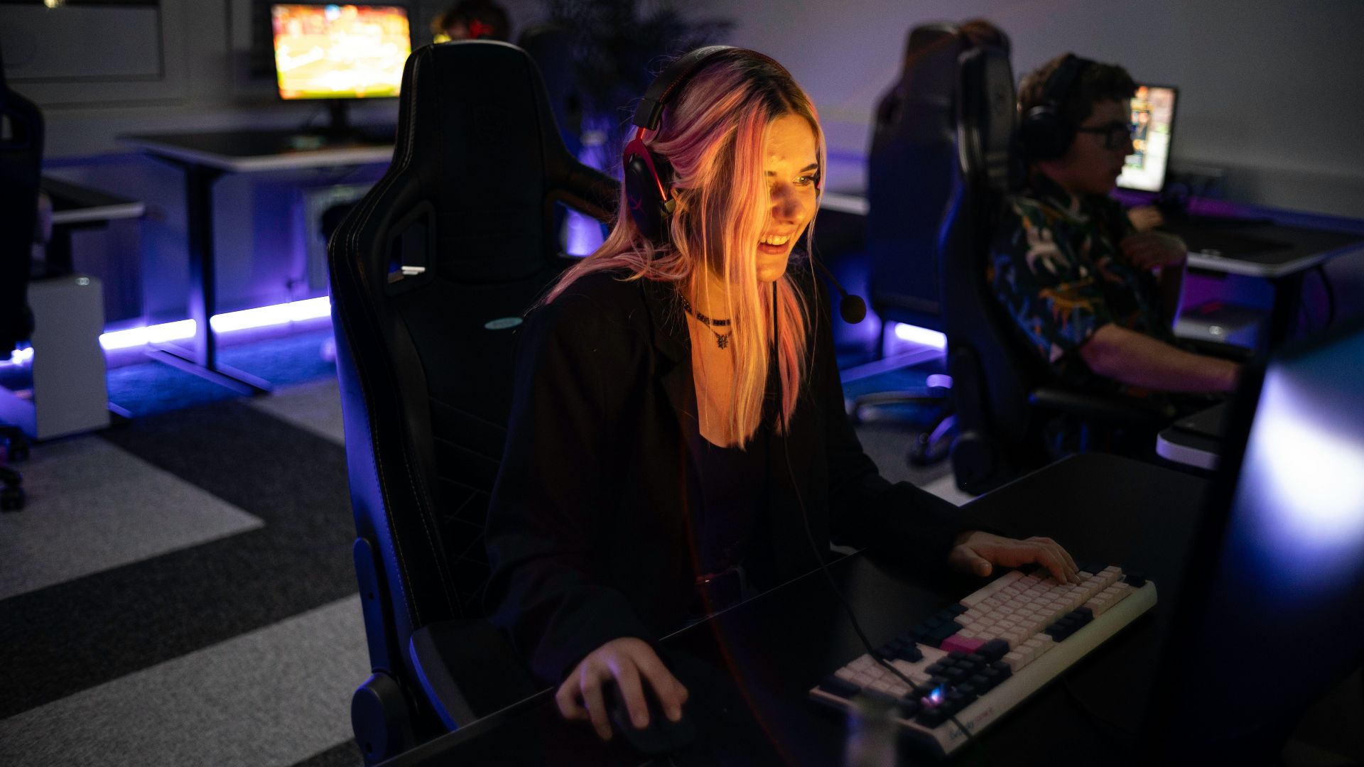 A woman sitting in front of a computer monitor