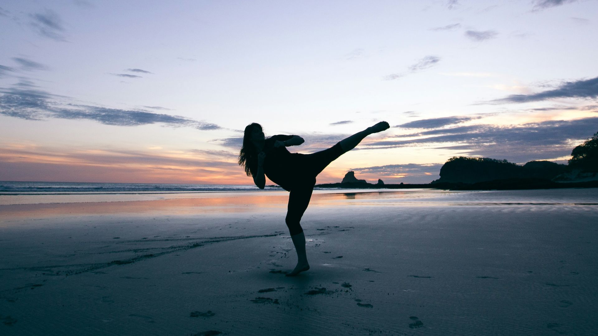 silhouette of person kicking on mid air
