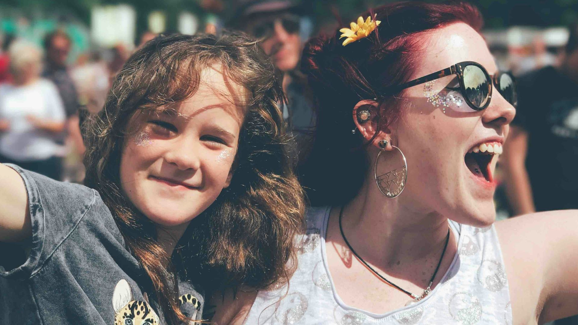 girl and woman near people at the field during day