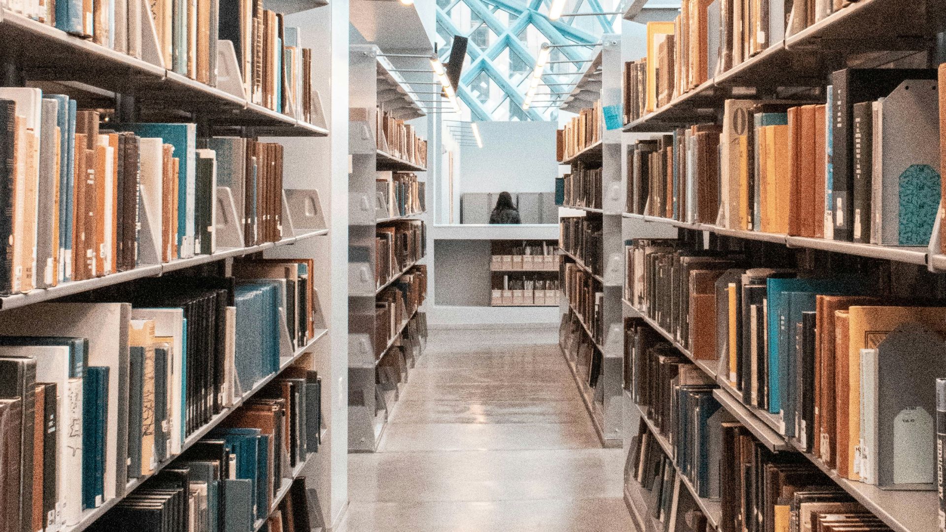 brown wooden book shelves in library