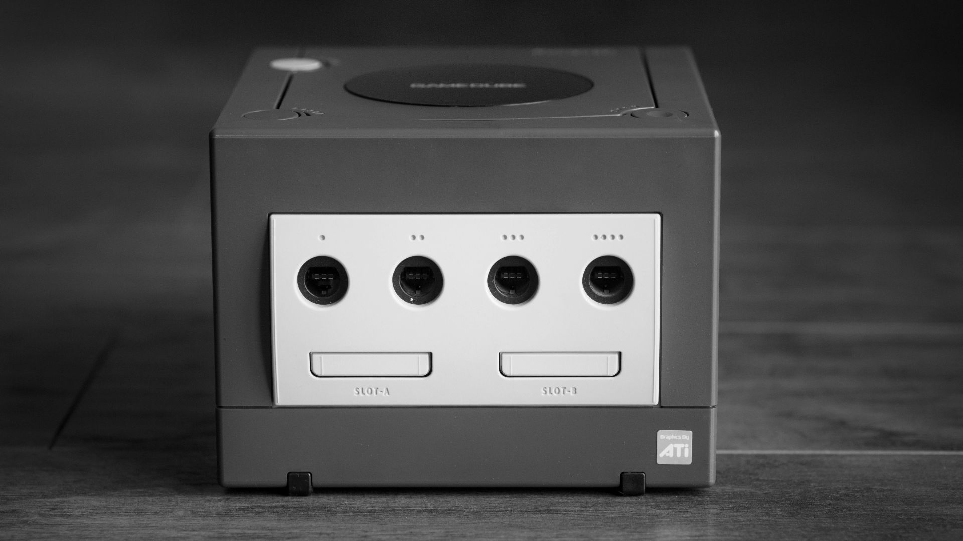 white and black Nintendo GameCube on gray surface