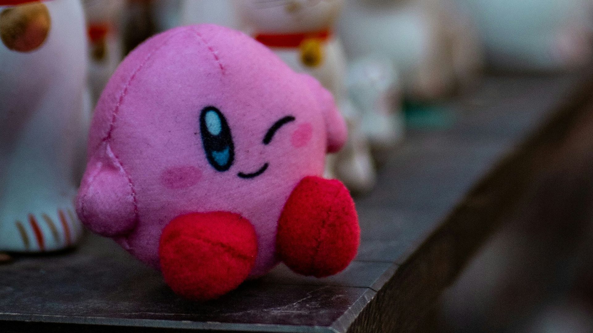 a group of small white cats sitting on top of a shelf