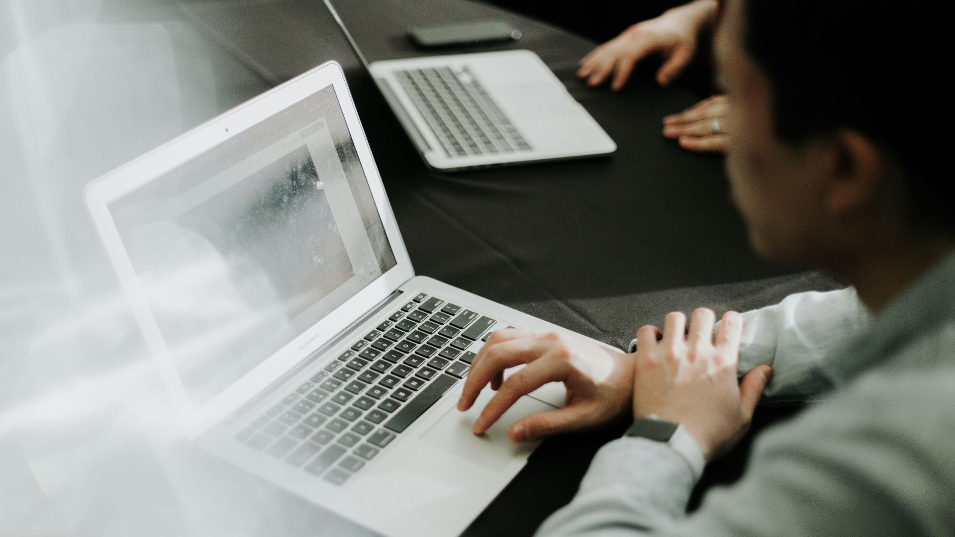a man sitting in front of a laptop computer