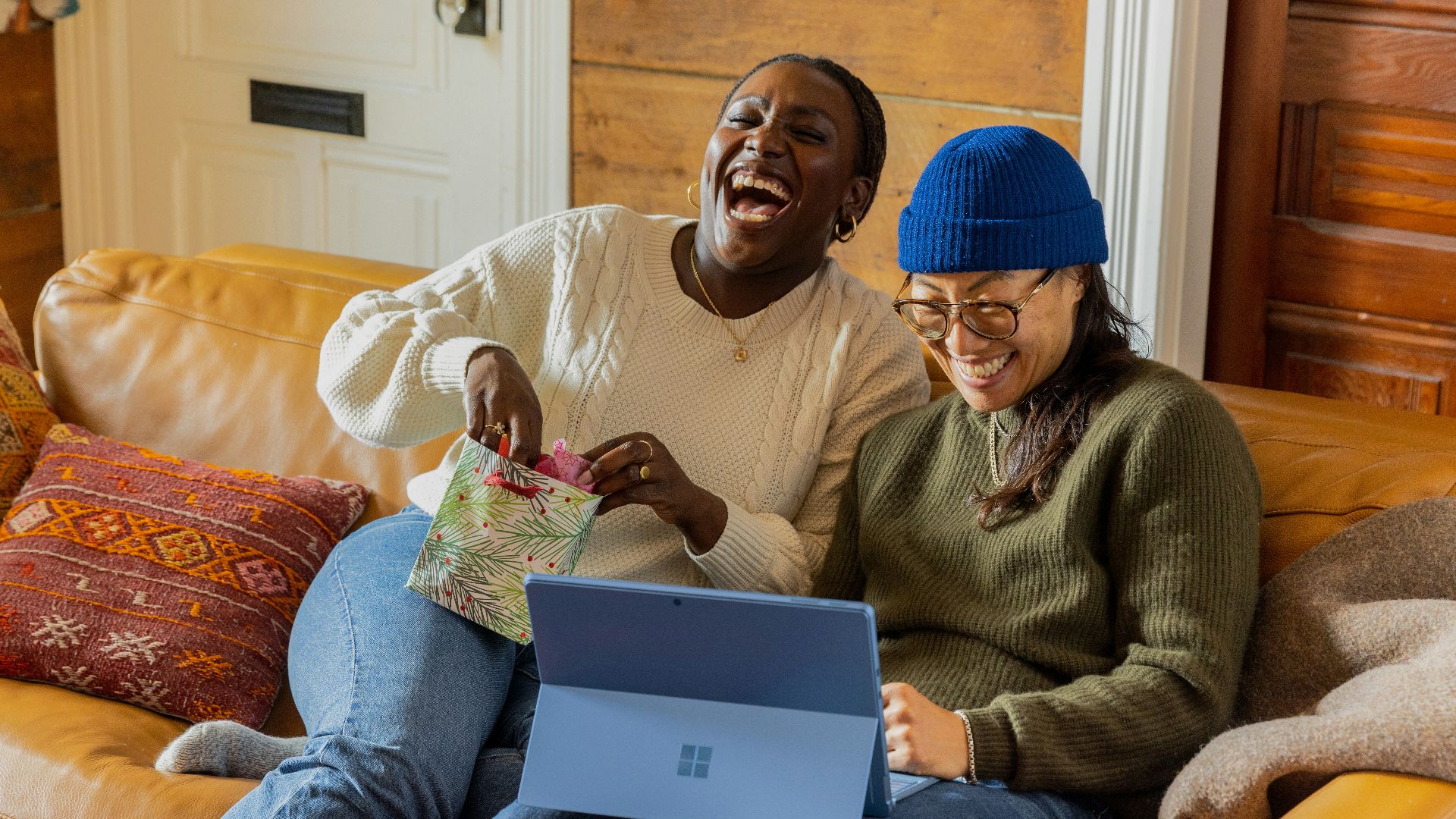 a person sitting on a couch with a laptop