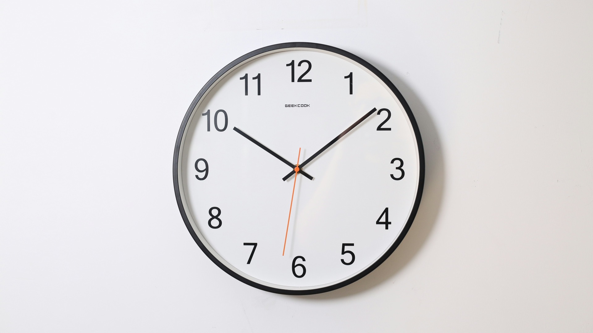round analog wall clock pointing at 10:09