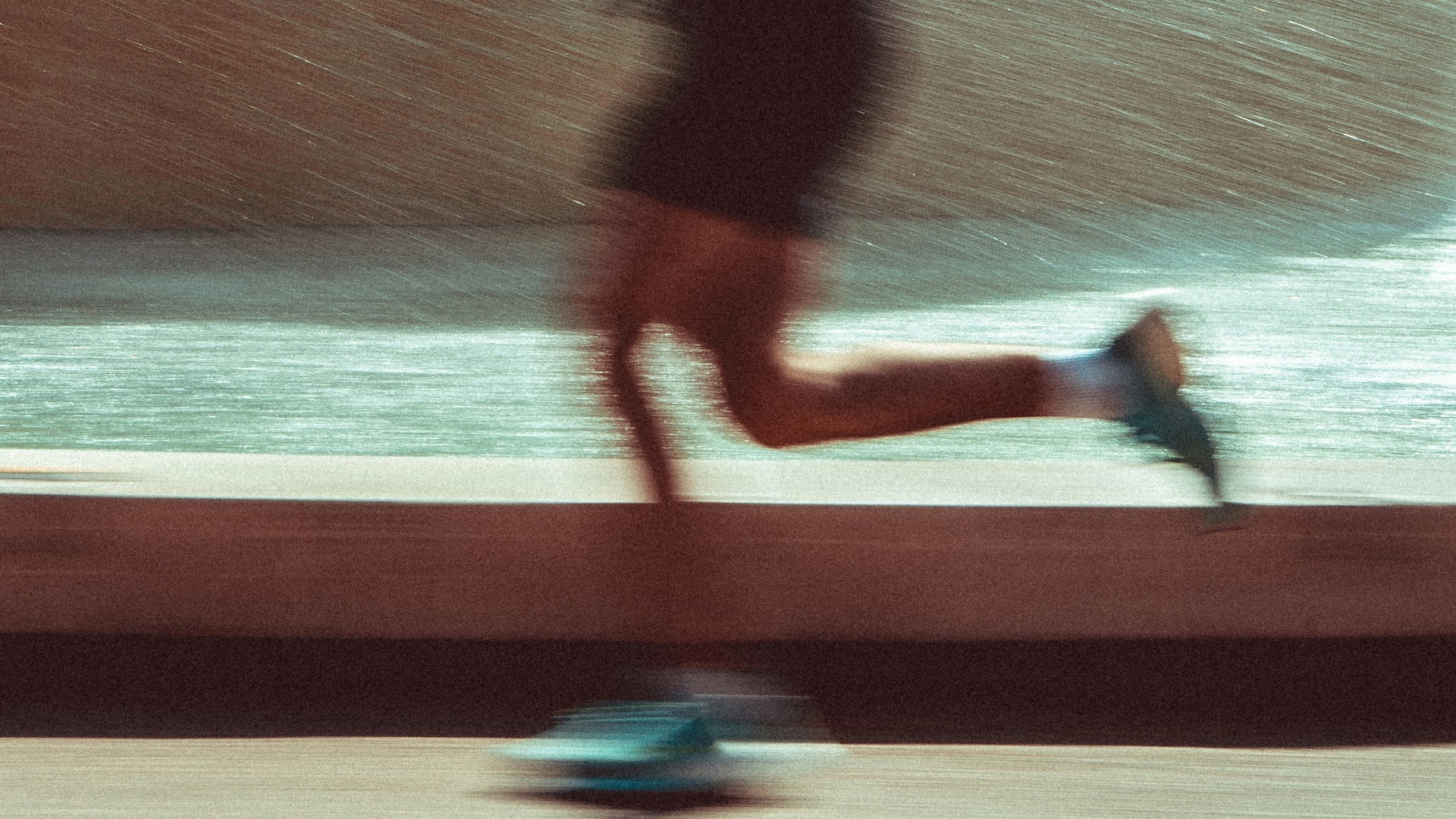 A man running down a street next to a fountain