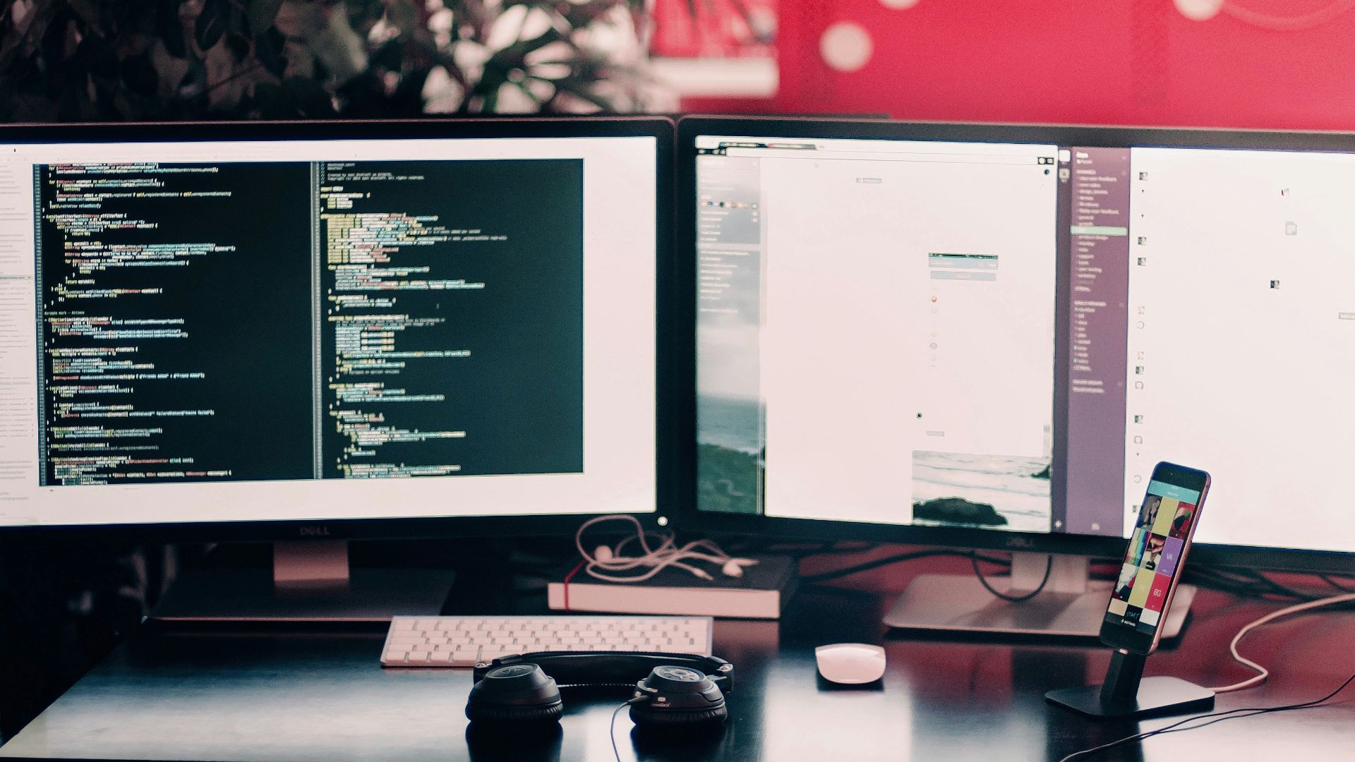 two black computer monitors on black table