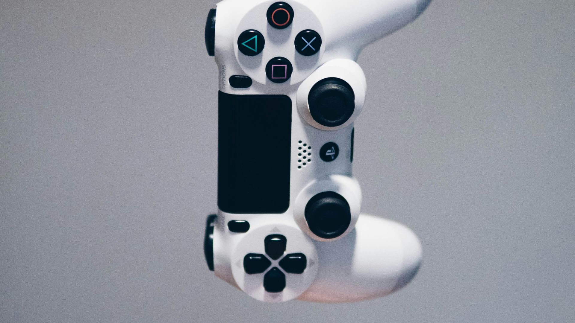 white Sony PS4 DualShock controller over person's palm