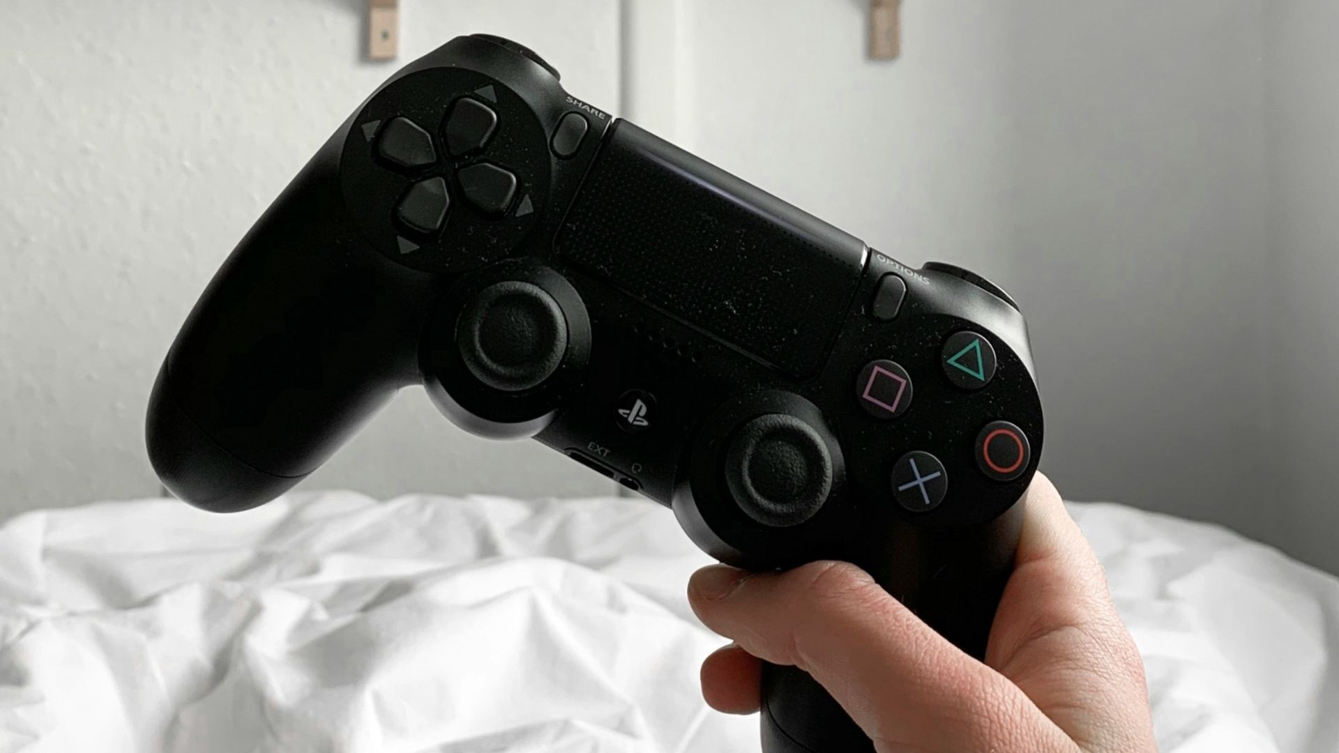 person holding black sony ps 4 controller