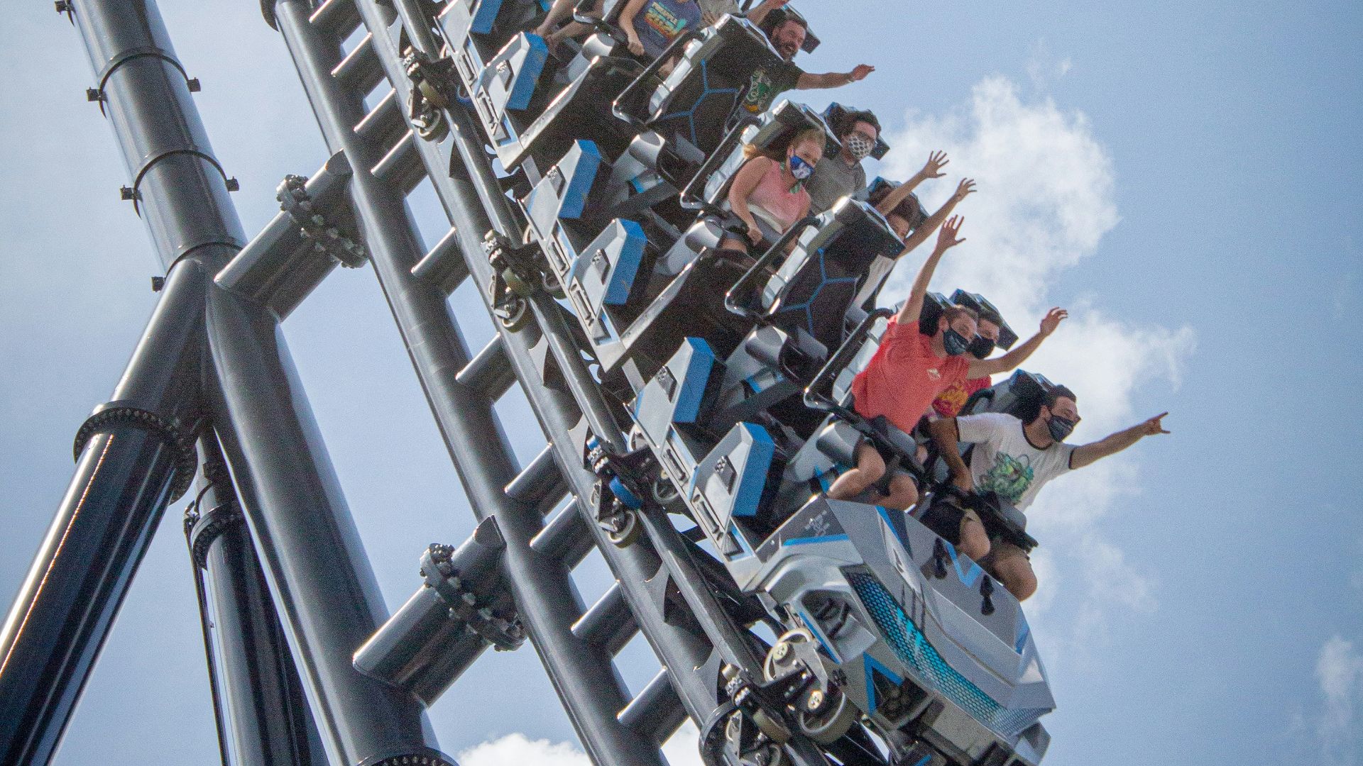 people riding on roller coaster during daytime