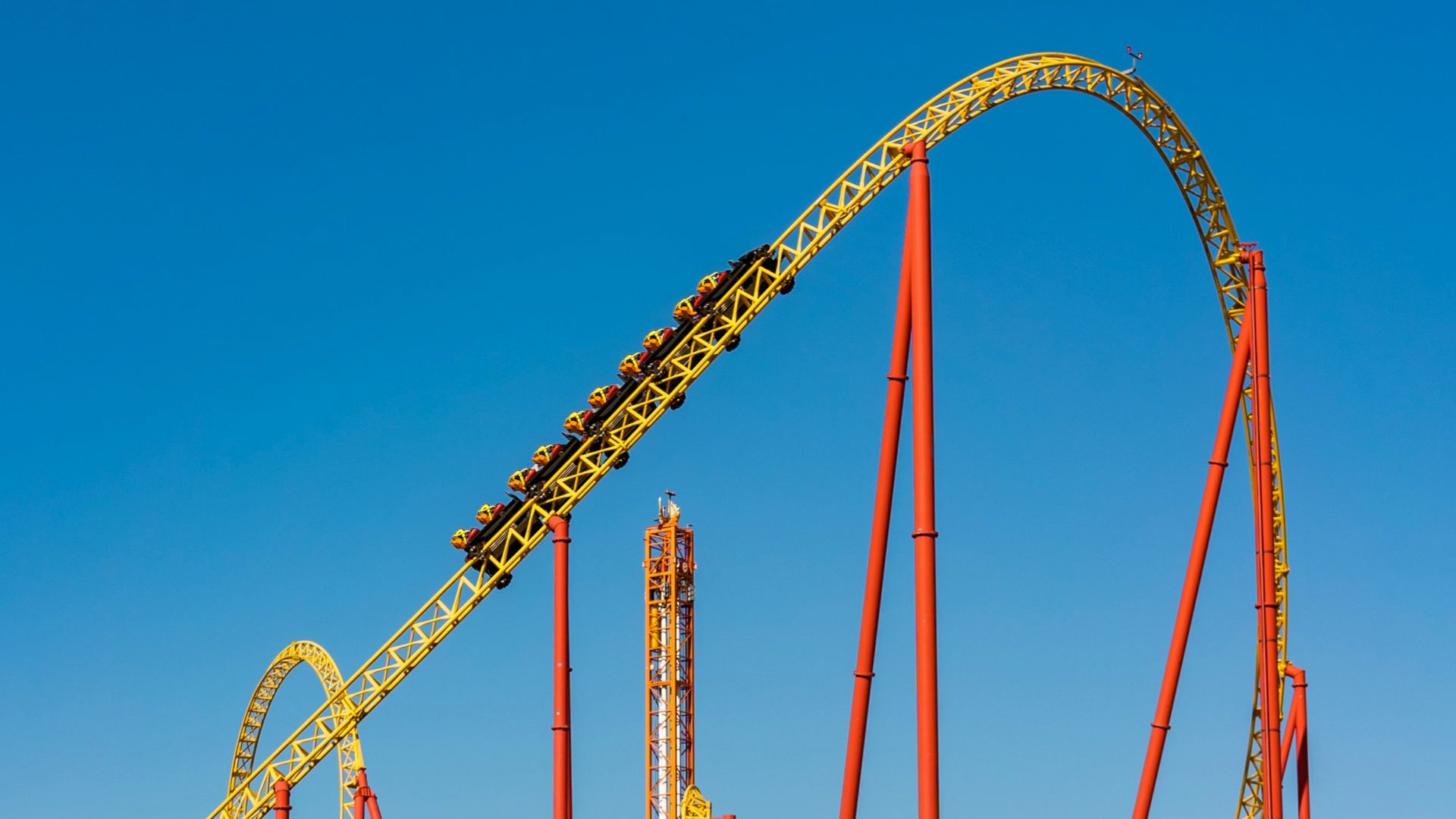 a roller coaster in an amusement park on a clear day