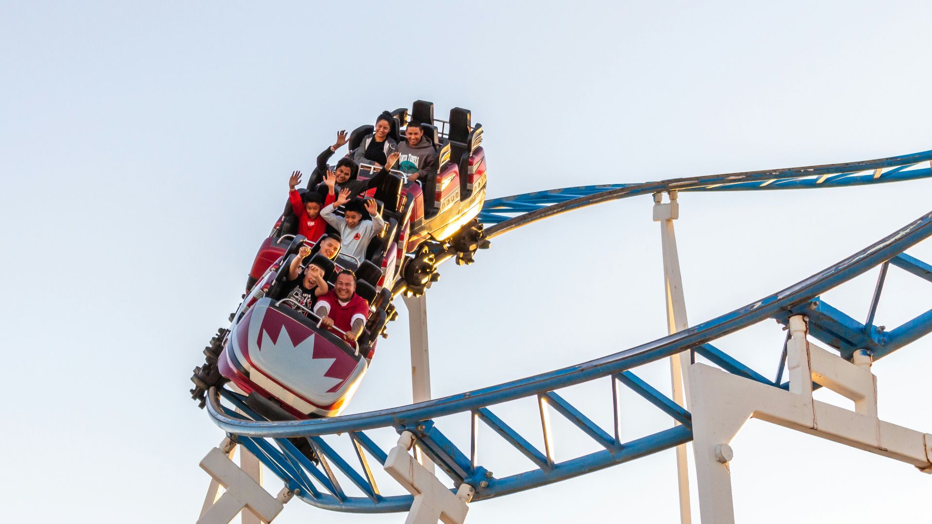 people riding roller coaster during daytime