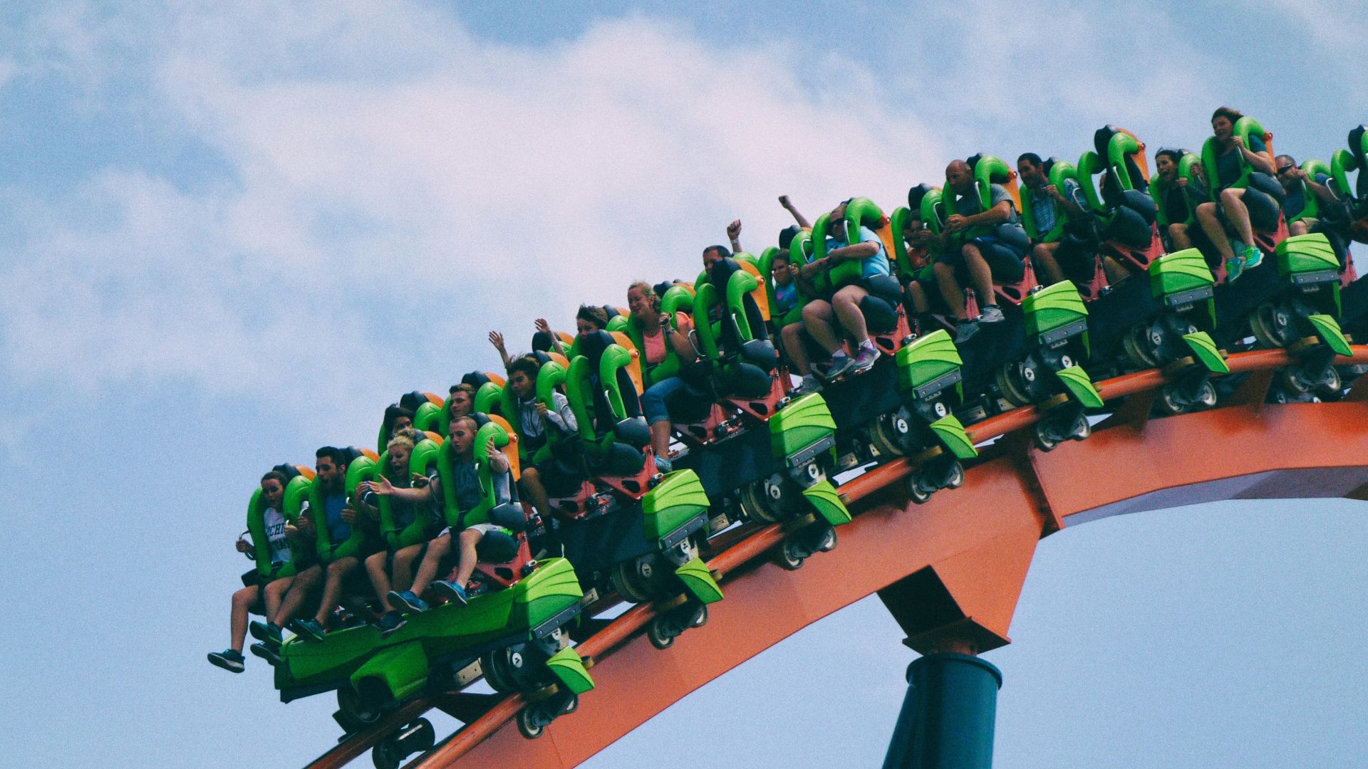 people riding on roller coaster