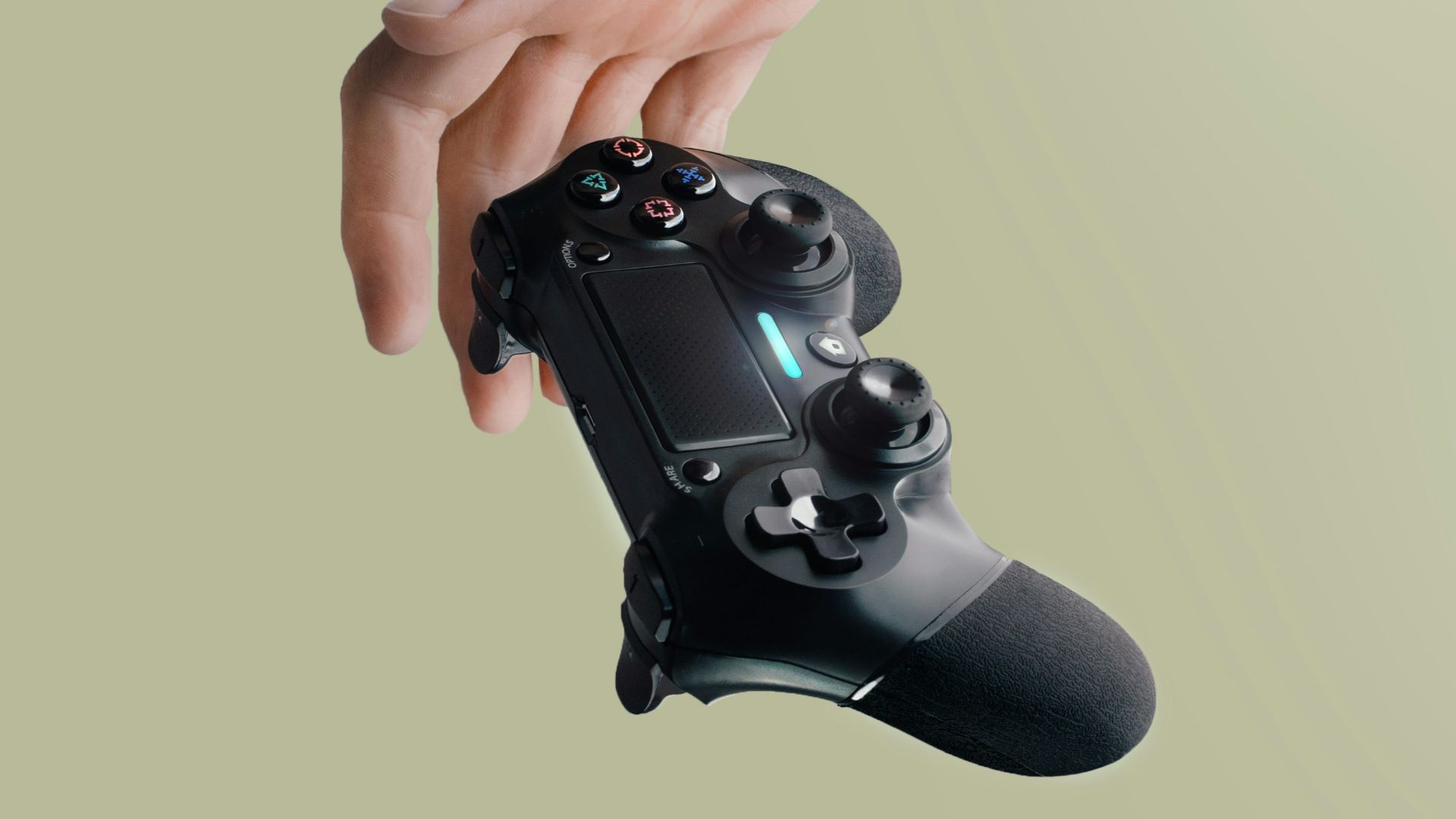 person holding Sony DualShock 4 wireless controller