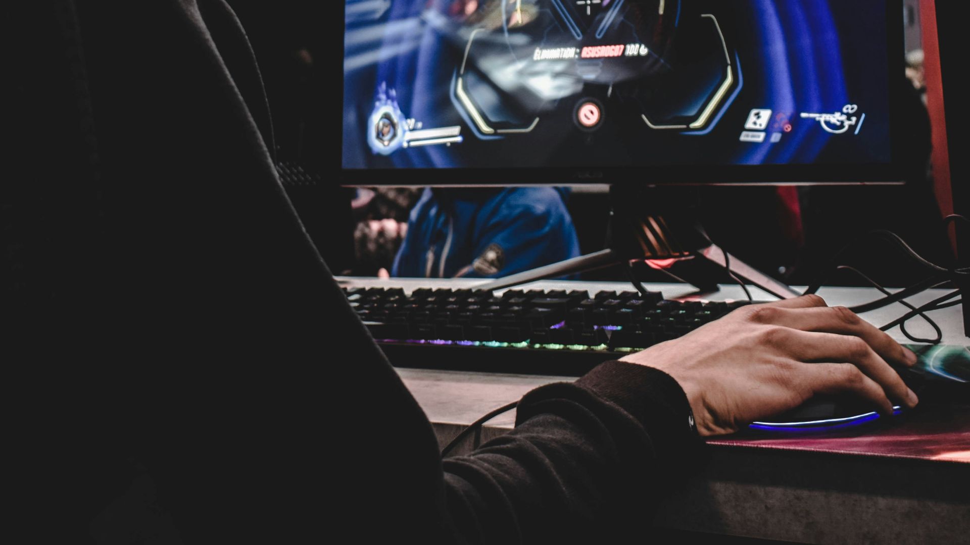 person sitting on gaming chair while playing video game