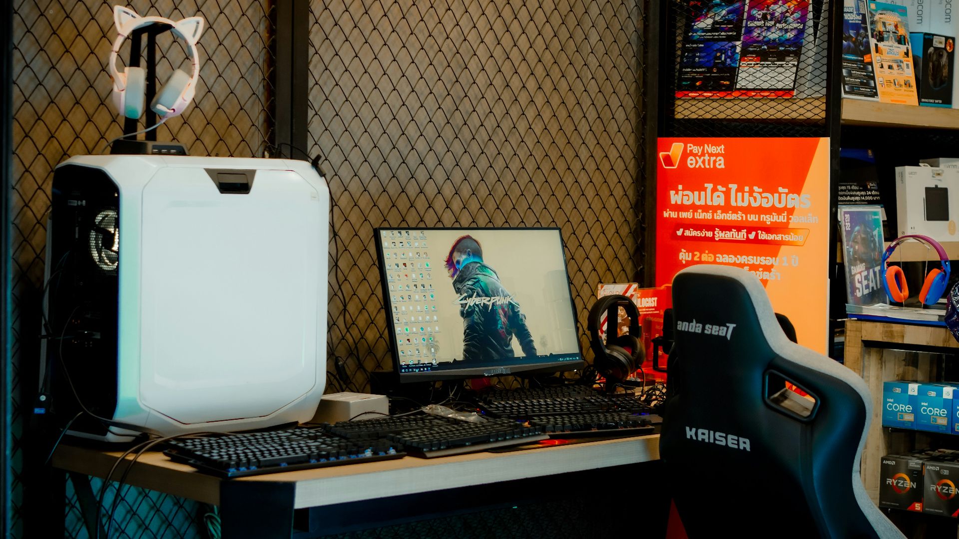 a computer desk with a monitor and a laptop on it