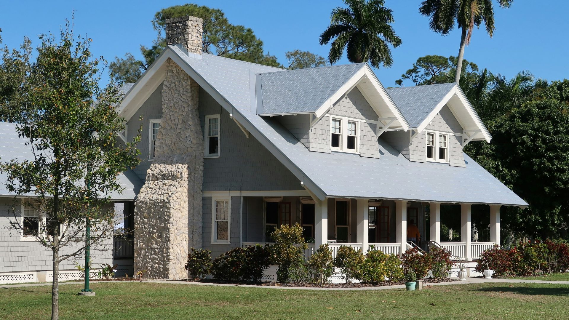 brown and white concrete house near green grass field during daytime