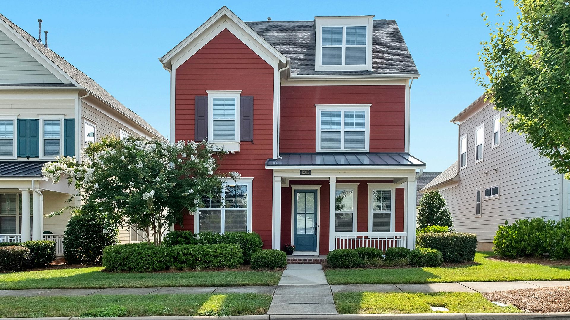 white and brown concrete house near green trees during daytime