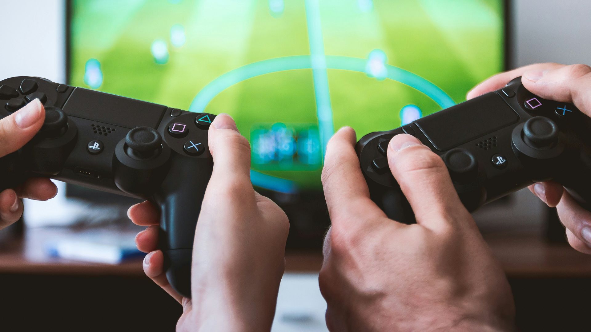 two people playing Sony PS4 game console
